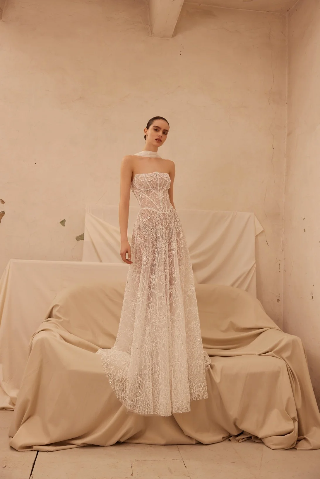 Jamini wedding dress by Olya Mak featuring a strapless corset bodice, intricate lace embellishment, subtle sparkle and flowing ivory A-line skirt. Exclusive at Spellbound Bridal, Arklow, Co Wicklow, Ireland.