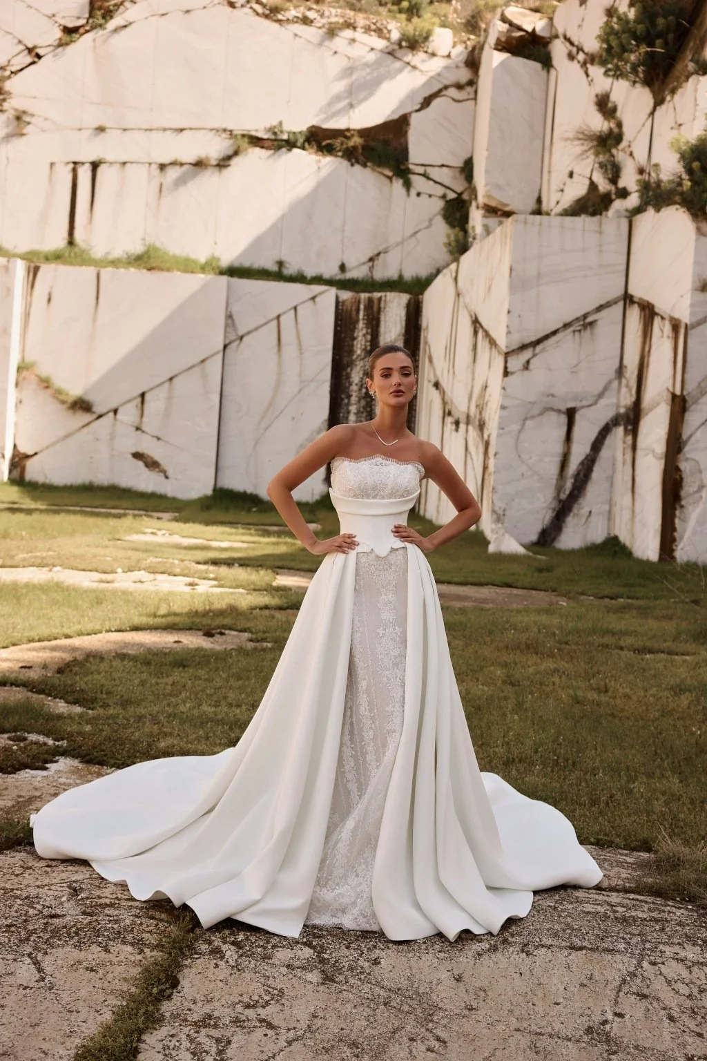 Discover Persephone by Katy Corso at Spellbound Bridal. An embellished guipure lace wedding dress with an optional sculpted corset overskirt for two striking bridal looks.