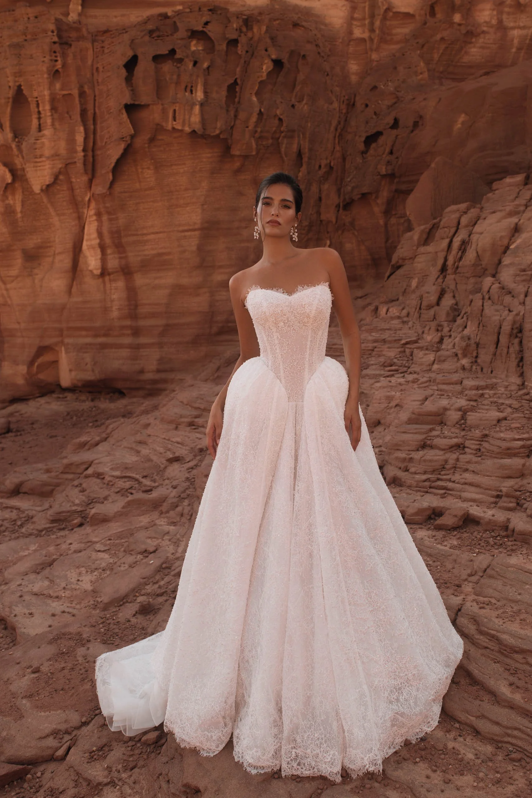 Discover the Betta wedding dress at Spellbound Bridal. A strapless princess gown in Chantilly lace with pearl detailing, voluminous skirt and detachable ruffles. Try her on in Wicklow, Ireland.