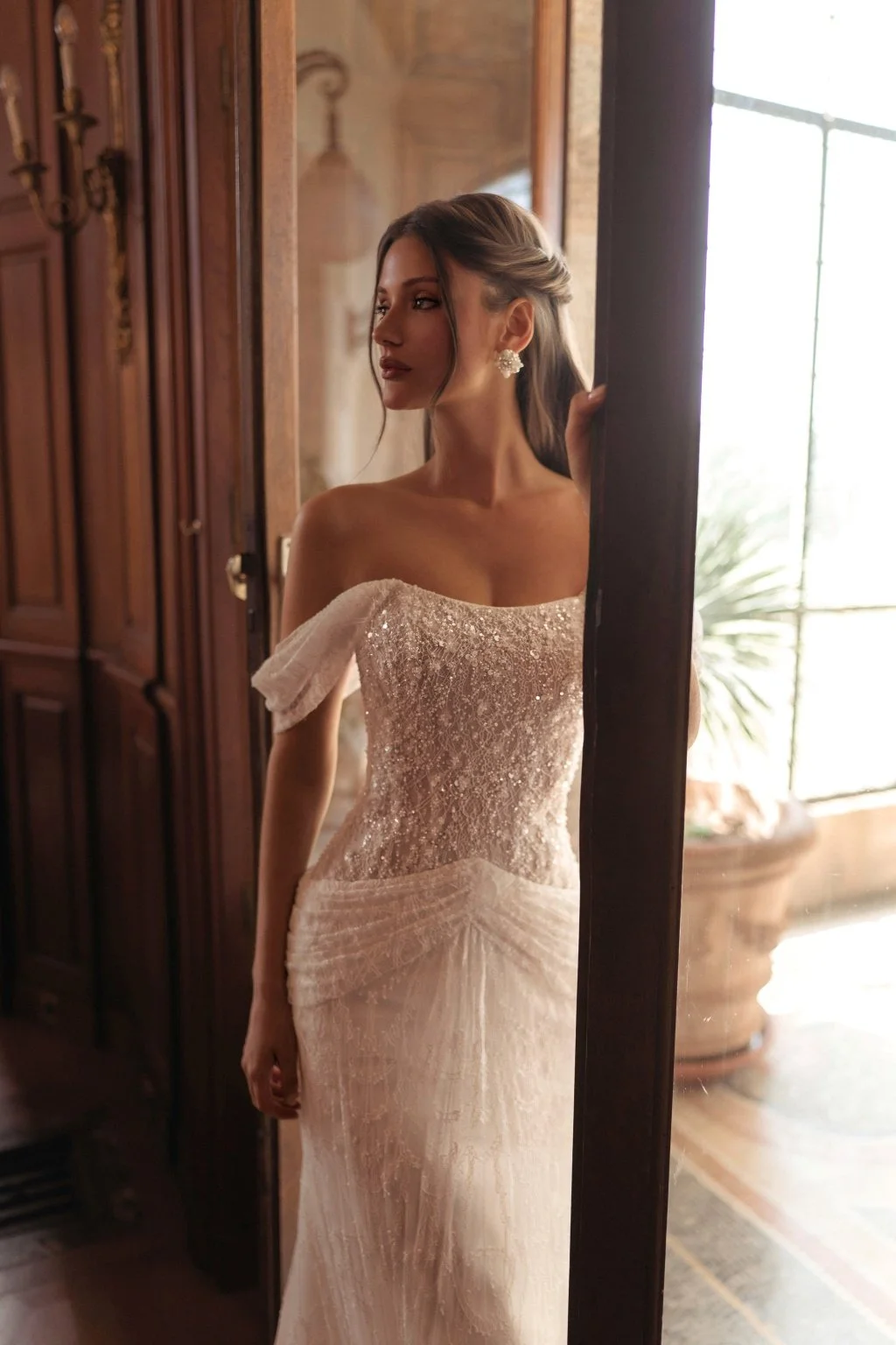 CORTEZ is an exquisite wedding dress made of delicate Guipure lace, embroidered with sequins and decorated with beaded flowers on top. The on-trend of incorporating draping into your wedding aesthetic features on the hips of CORTEZ. The lowered strap