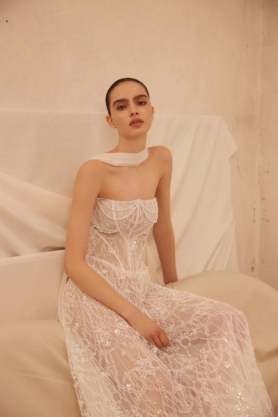 Jamini wedding dress by Olya Mak featuring a strapless corset bodice, intricate lace embellishment, subtle sparkle and flowing ivory A-line skirt. Exclusive at Spellbound Bridal, Arklow, Co Wicklow, Ireland.