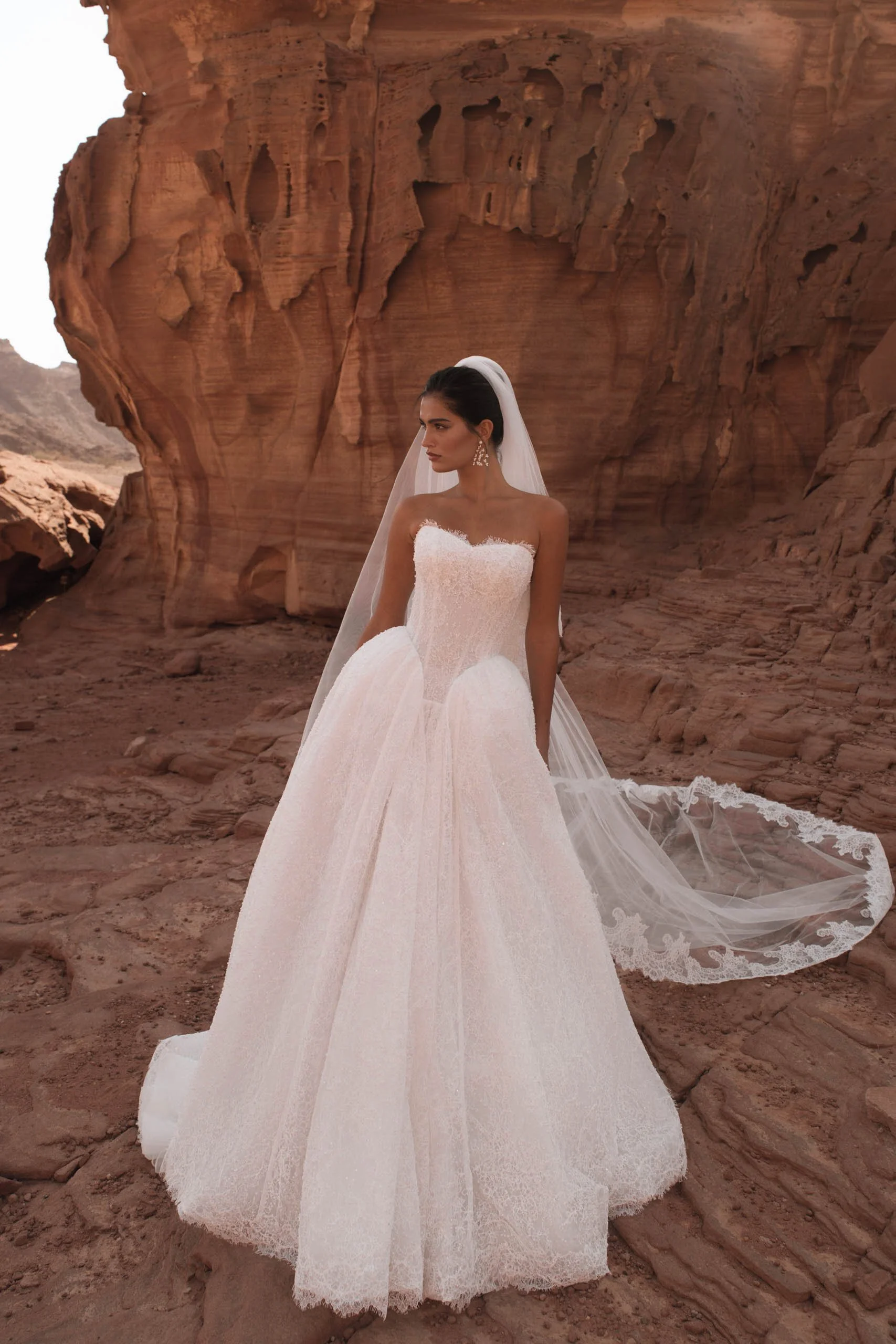 Discover the Betta wedding dress at Spellbound Bridal. A strapless princess gown in Chantilly lace with pearl detailing, voluminous skirt and detachable ruffles. Try her on in Wicklow, Ireland.