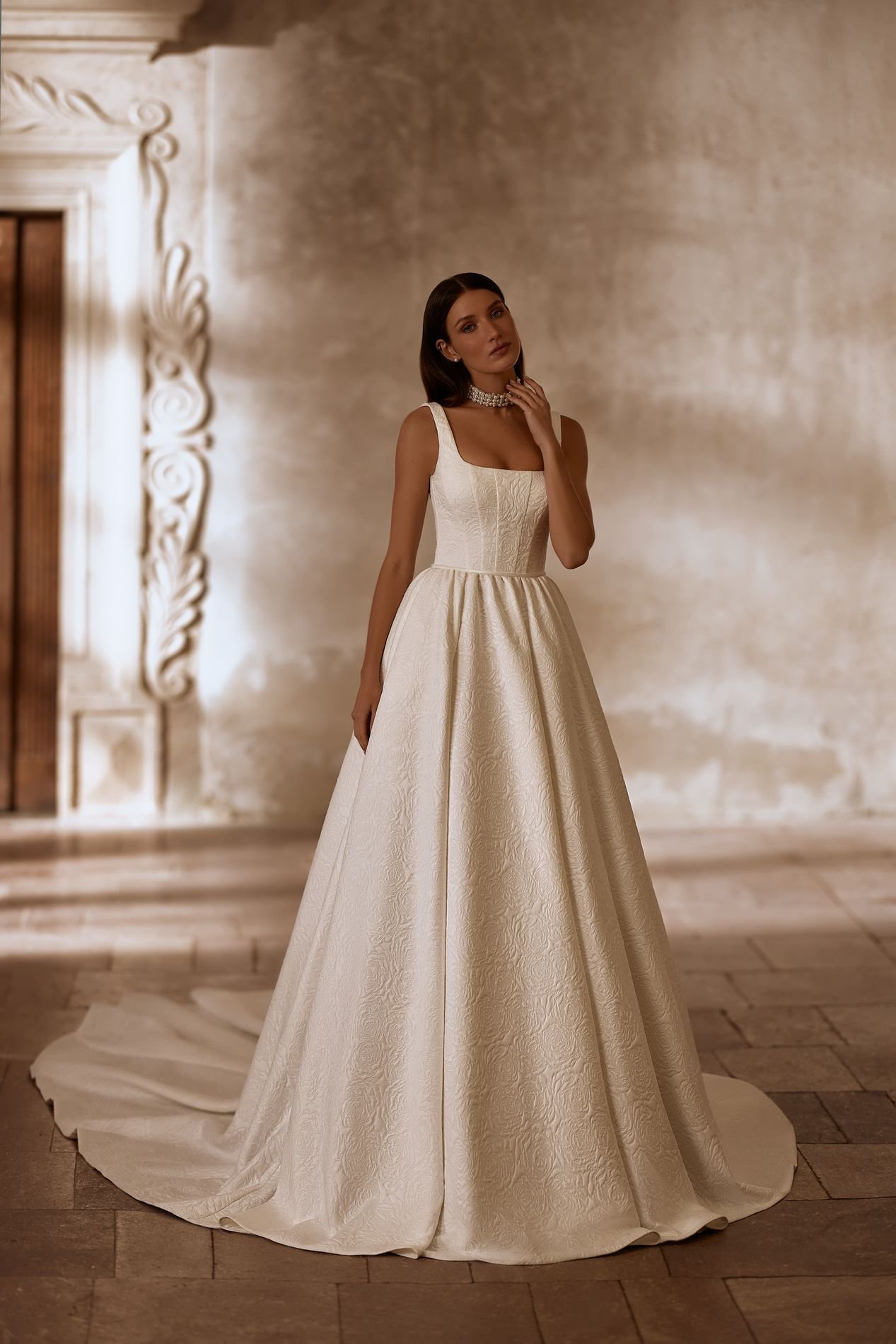 MARVIN is an exquisite square neckline princess ballgown wedding dress available in two luxury jacquard fabric variations. This textured look bridal gown with wide straps and a long train is classically elegant. Exclusively available at Spellbound Br