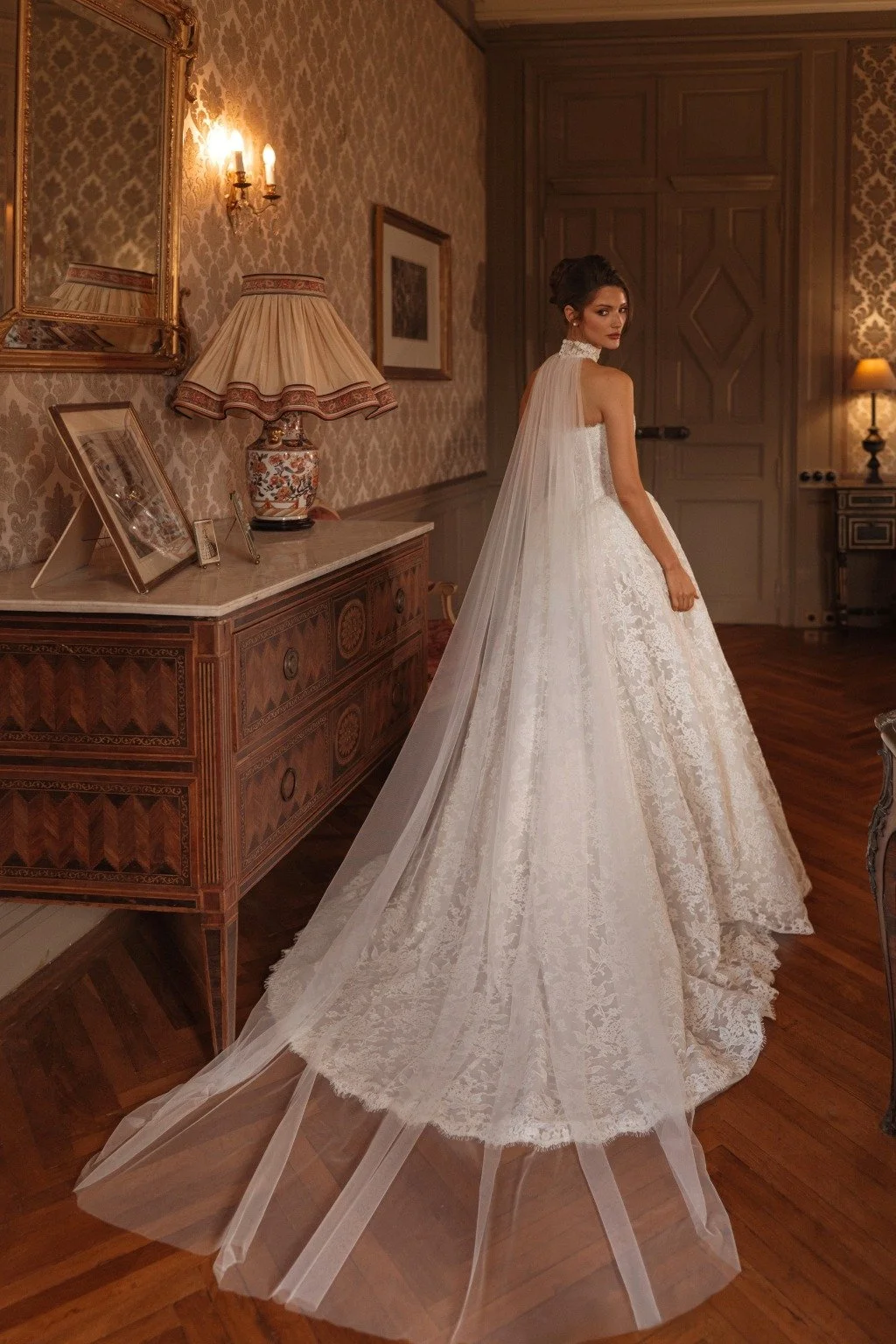 AVEL is a Chantilly lace ballgown style wedding dress. Brides can choose to complete their wedding day look with a lace choker that extends into a long cape-style train. Exclusively available at Spellbound Bridal, Wicklow, Ireland.
Dress Designer: Ka