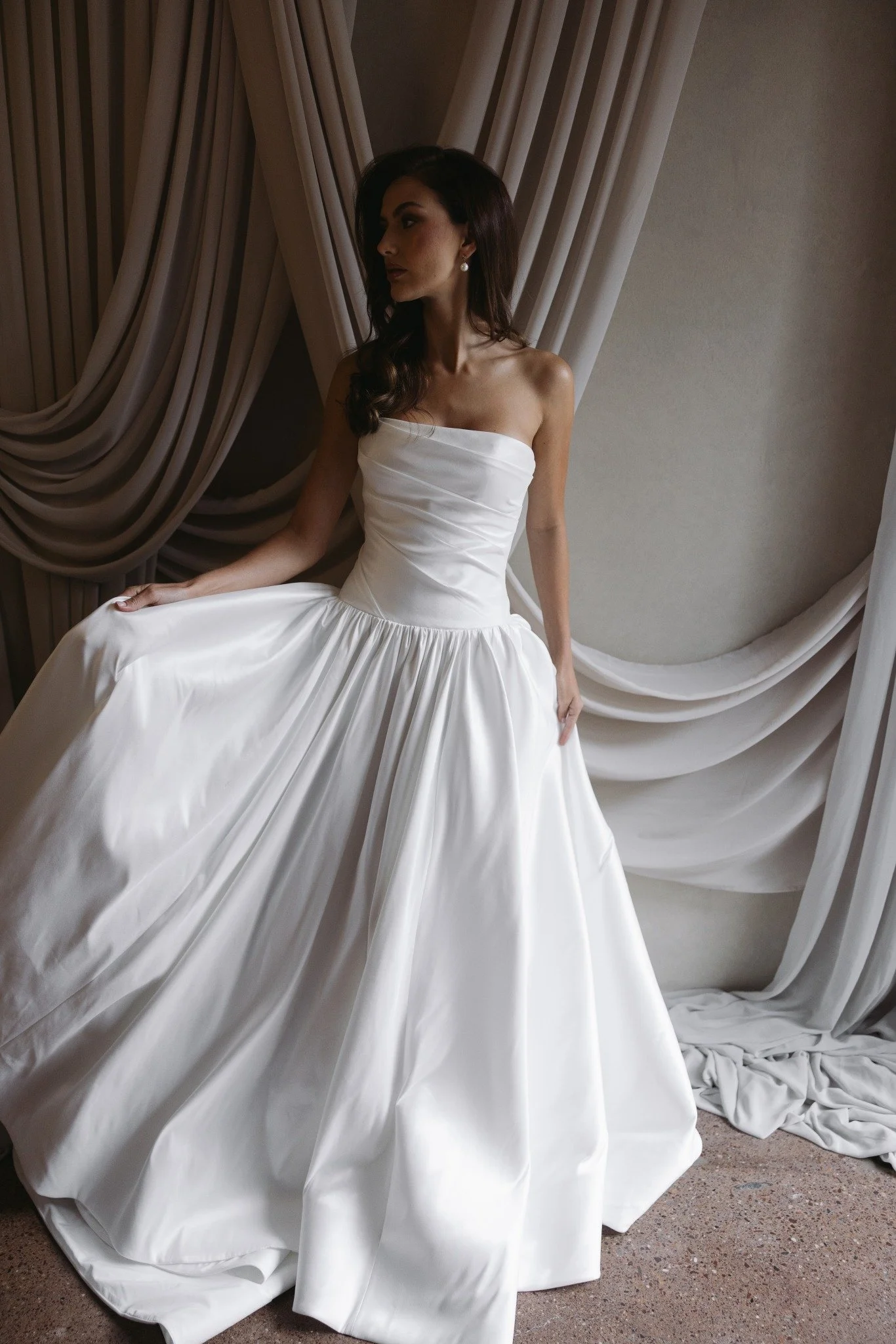 Aneta by Trish Peng stretch Mikado wedding dress featuring a modern drop waist, expertly ruched bodice and elegant A-line skirt, available at Spellbound Bridal Ireland.