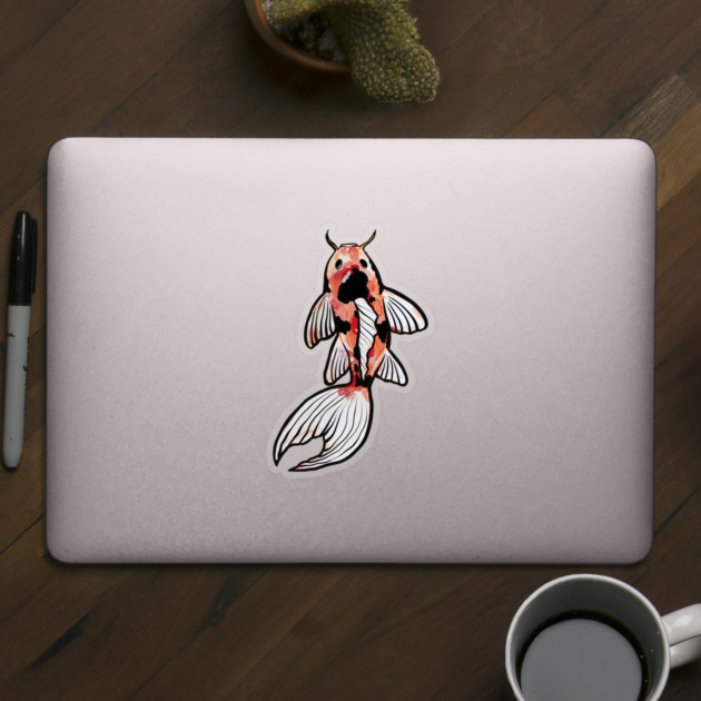 Laptop with a koi fish sticker, sitting on a wooden desk with a cactus, pen, and coffee cup.