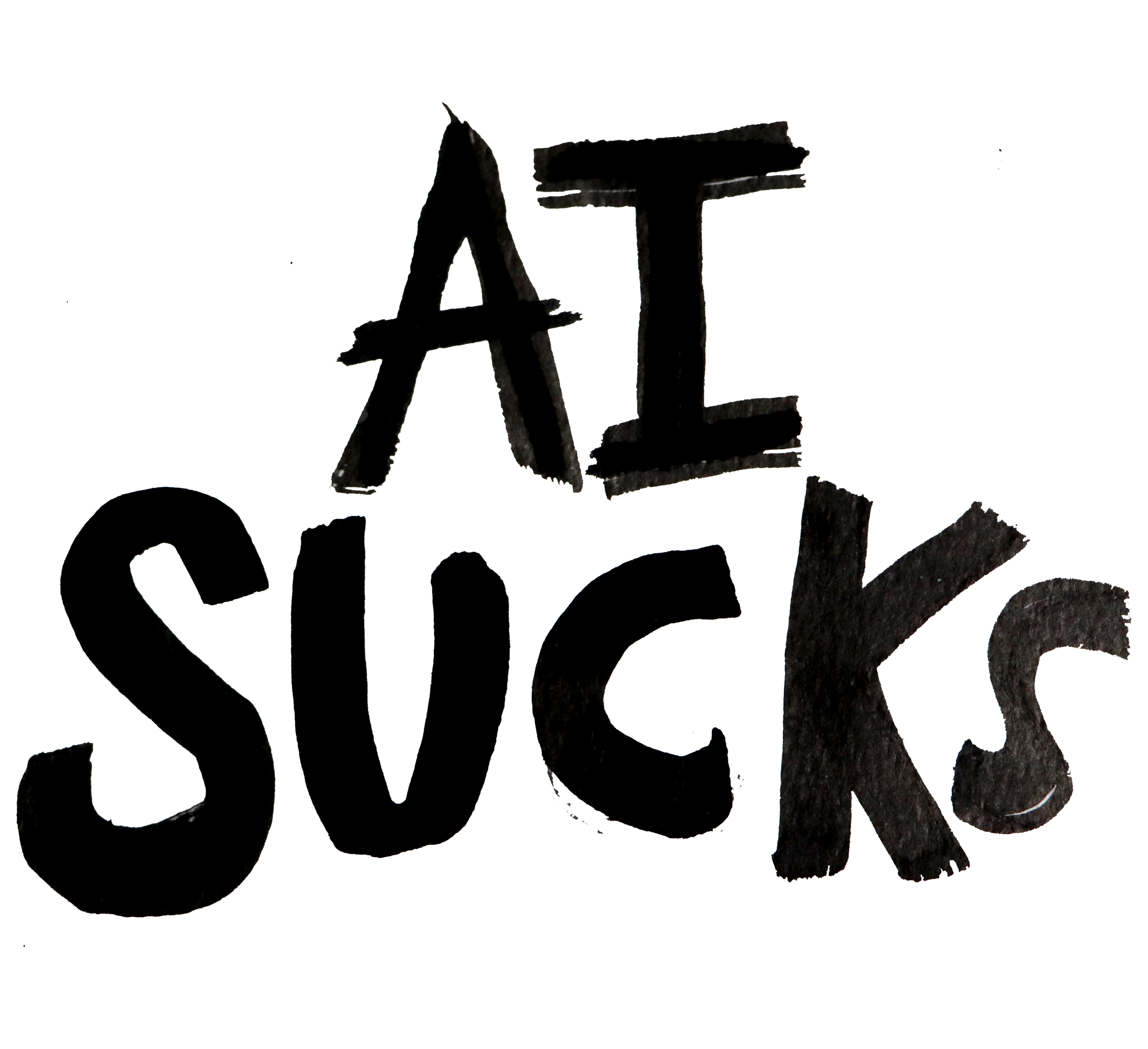 Close-up of the words AI SUCKS written in a black font on a surface with some rocks underneath.