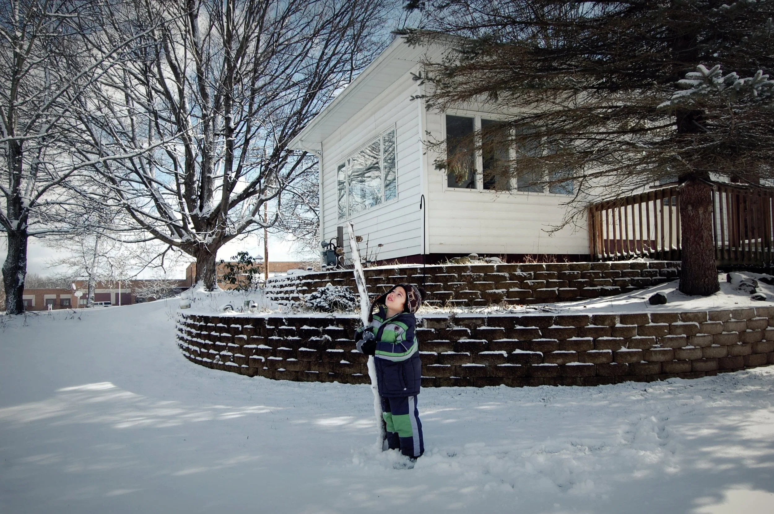 
"Experience the magic of a frosty Michigan winter through the eyes of a bundled little boy in the snow. Amid crisp air and snowy landscapes, this heartwarming scene captures the joy of childhood adventures in the cold. Perfect for evoking nostalgia 