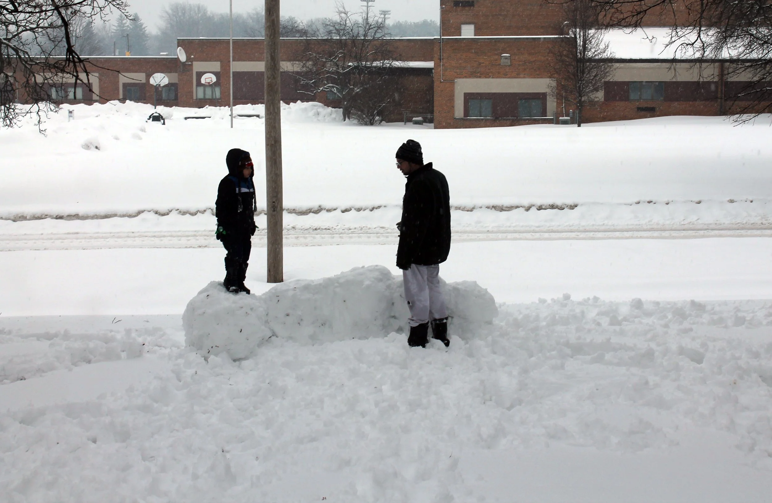 snow fort Heartwarming photo of a father and son bonding over their handcrafted snow fort in serene Concord, Michigan. A tribute to family, nature, and winter’s magic, this scene evokes the spirit of earth lovers, witchy vibes, and creative energy. P