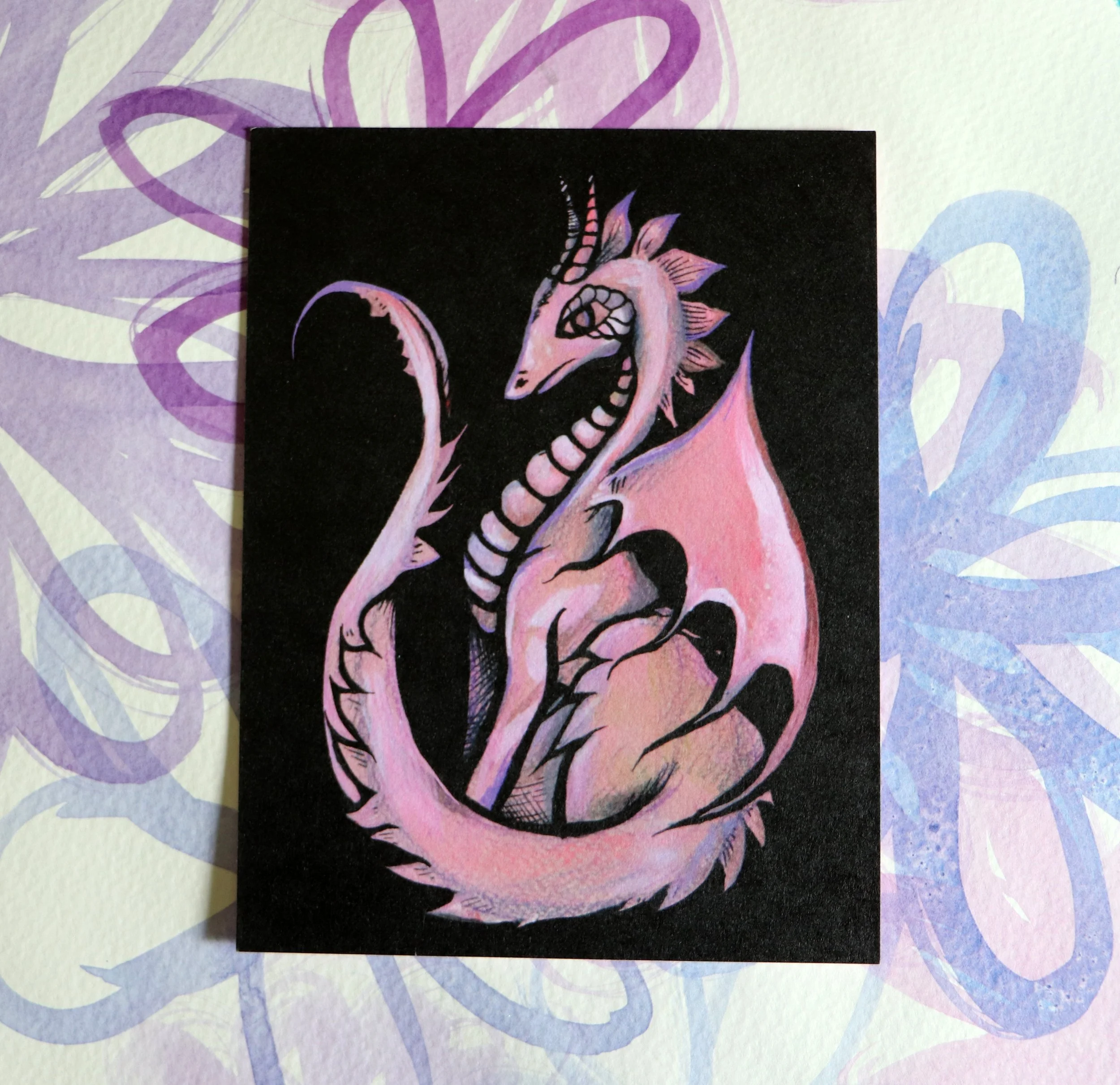 A colorful illustration of a Pink Dragon and a fierce expression, set against a black background with pink accents.