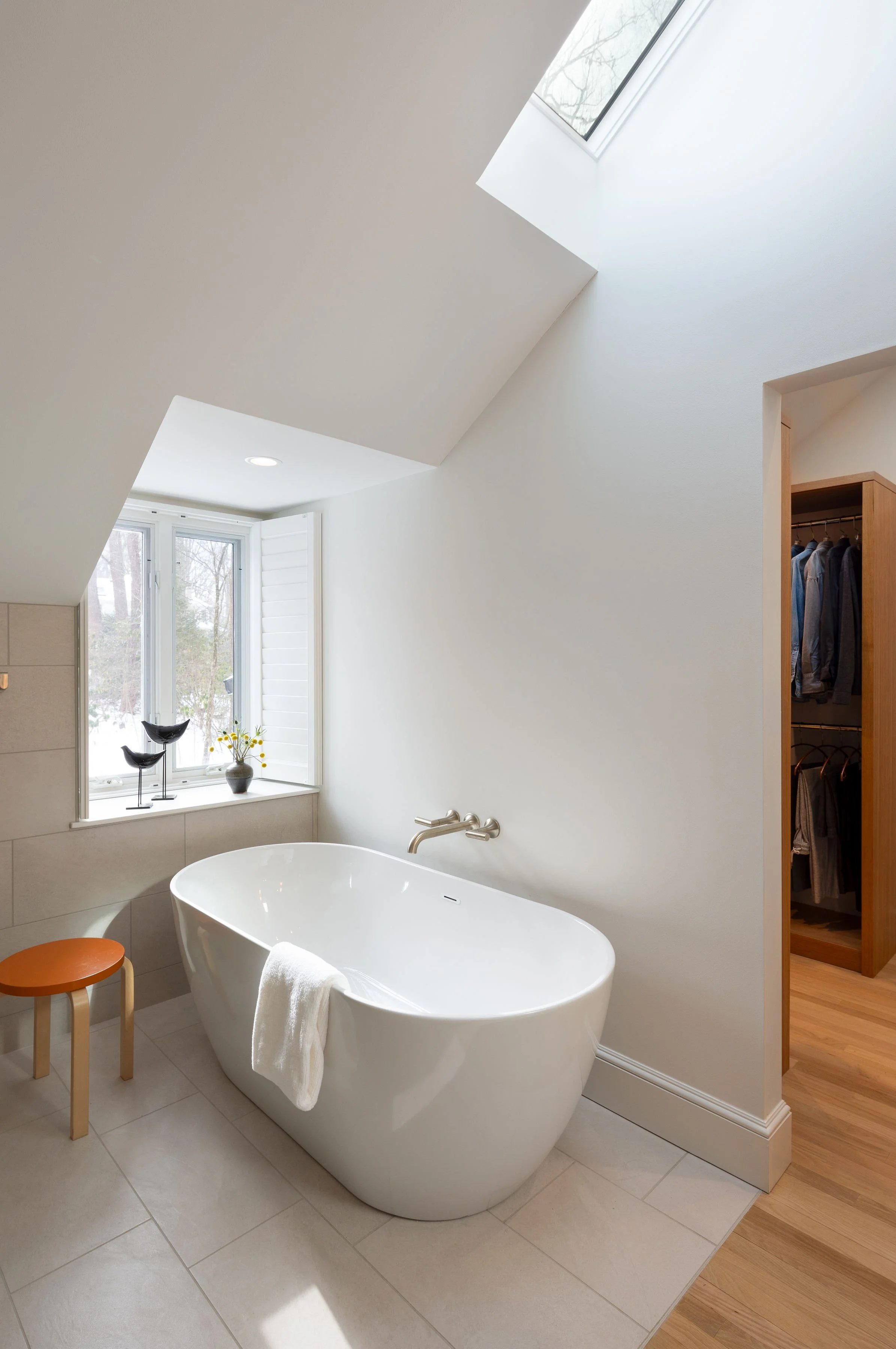 Modern white oak bathroom with large format wall tile and bathtub