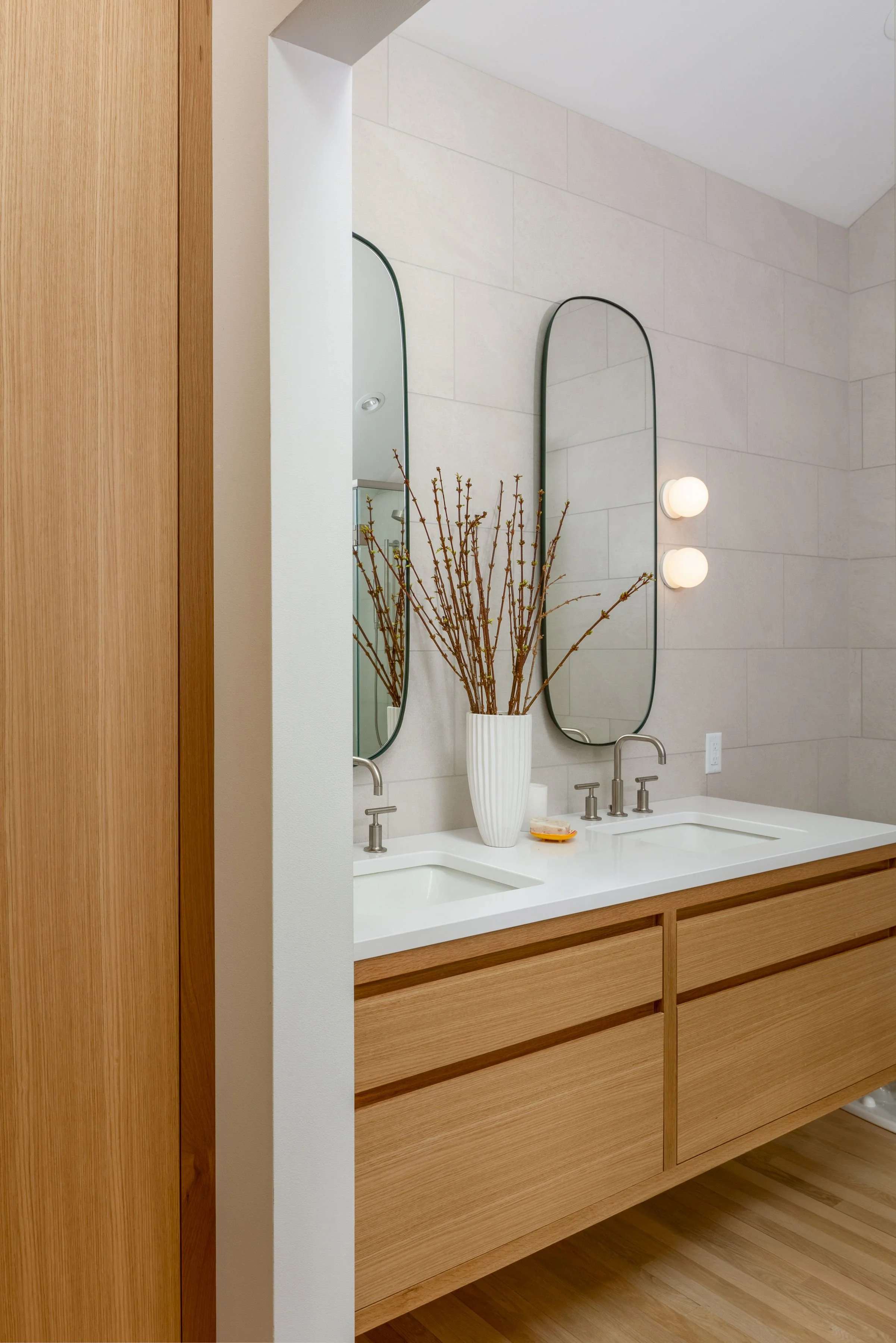 Modern white oak double vanity with large format wall tile