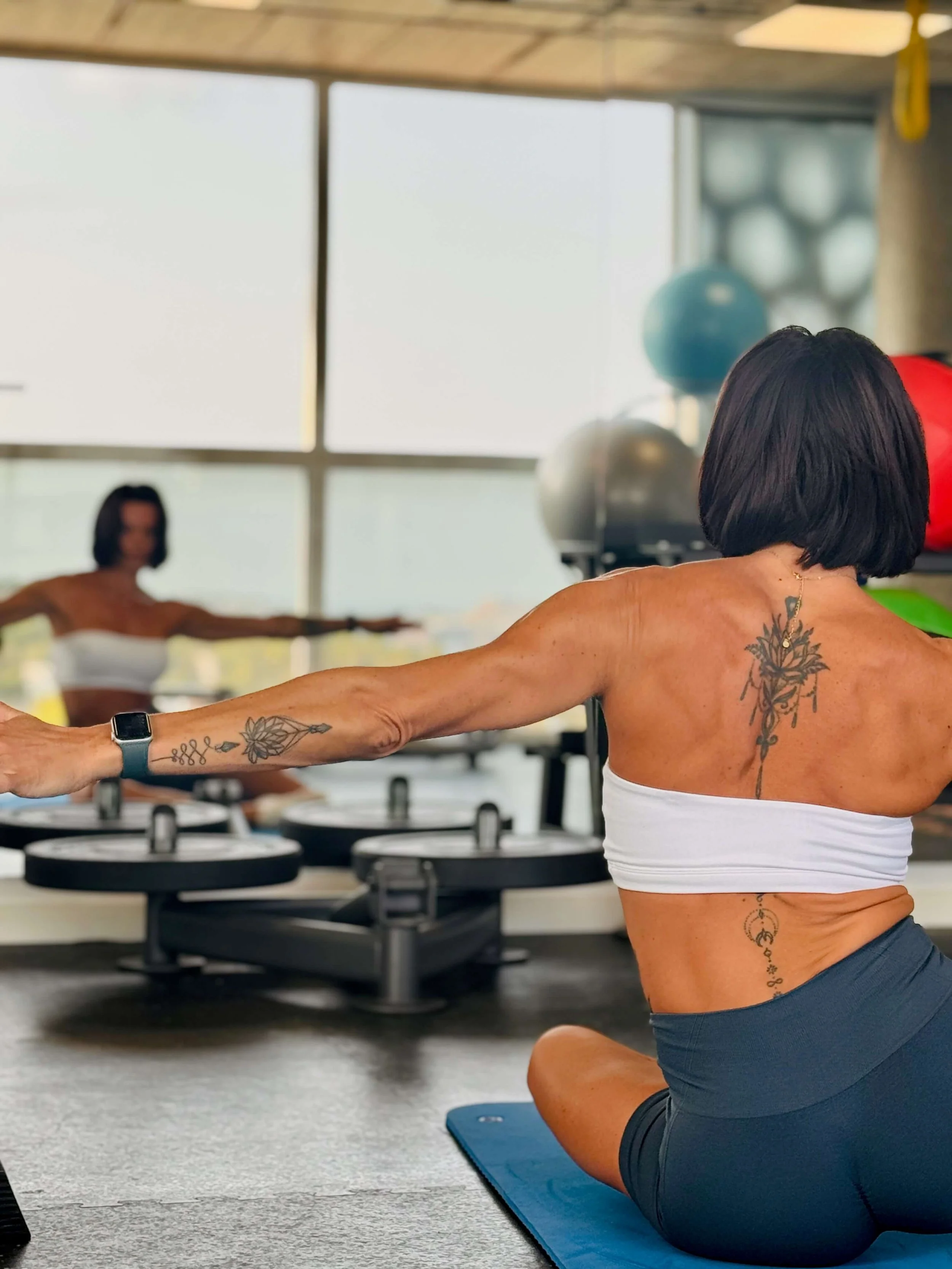 Claire doing a mobility routine in the gym.