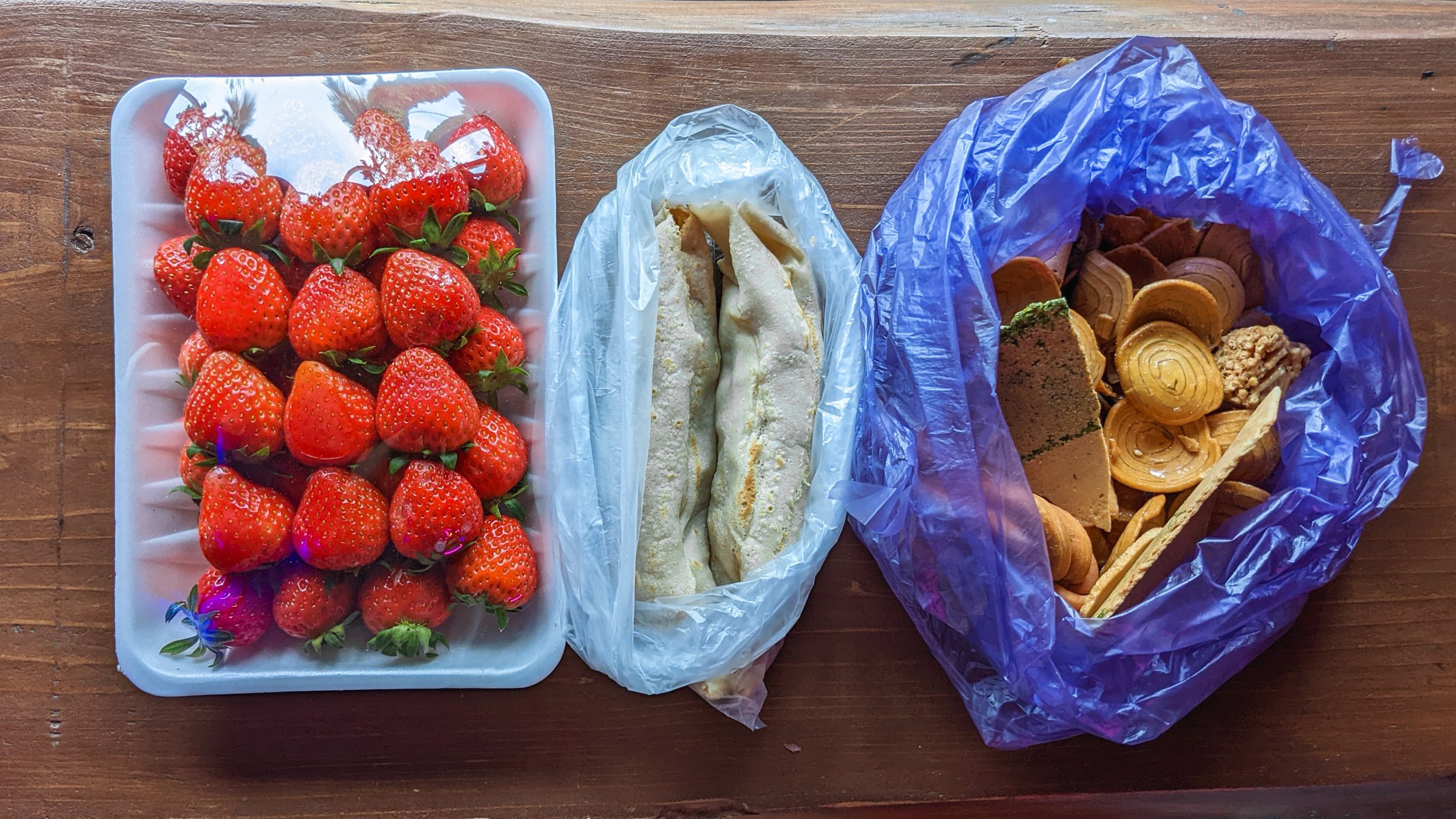  My spread from the market: strawberries, bingtteok, and a mixed bag of traditional Korean crackers 