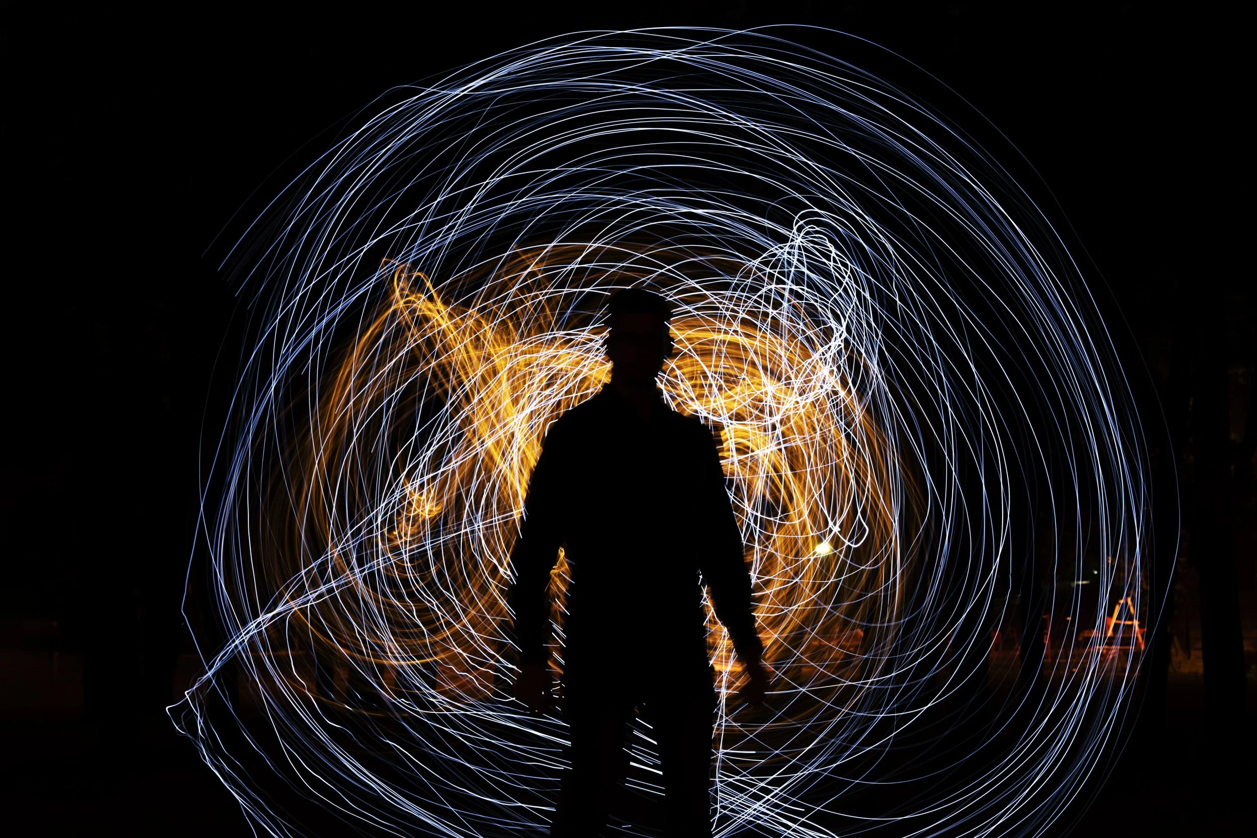 Man silhouetted against a lightshow in the background