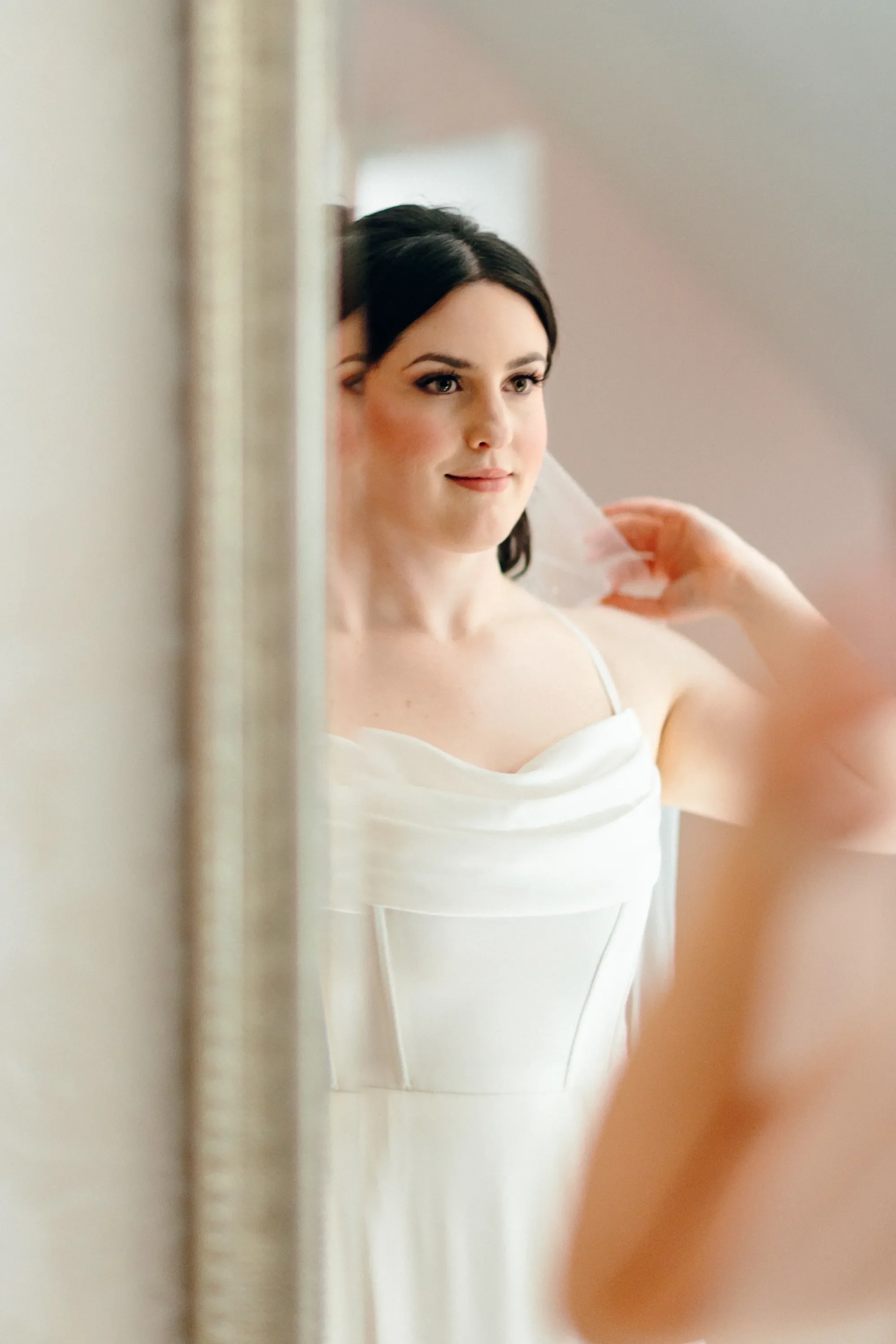 02-bride-lifting-veil-in-mirror-pilgrim-chapel-kansas-city.webp