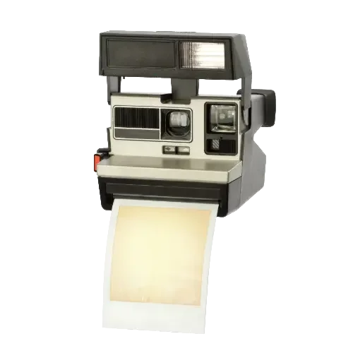 A vintage instant camera with a blank photo emerging, set against white—perfect inspiration for timeless wedding photography or KCMO wedding photography style.