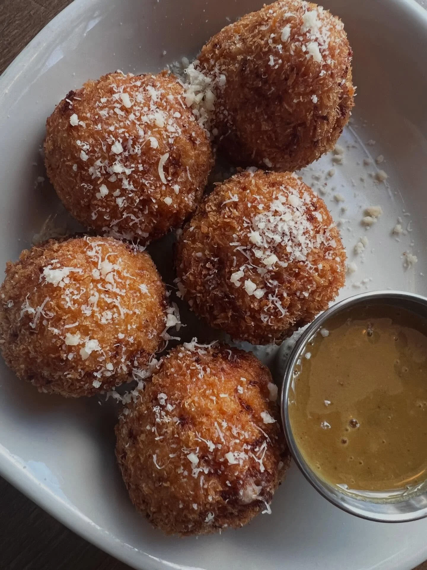 THESE ARE GOING TO FLY. ARANCINI MADE WITH OUR BEER CHEESE AND CHOPPED GENOA SALUMI. SERVED WITH HONEY DIJON SAUCE. #arancini#eastowngr#uptowngrgrandraoids