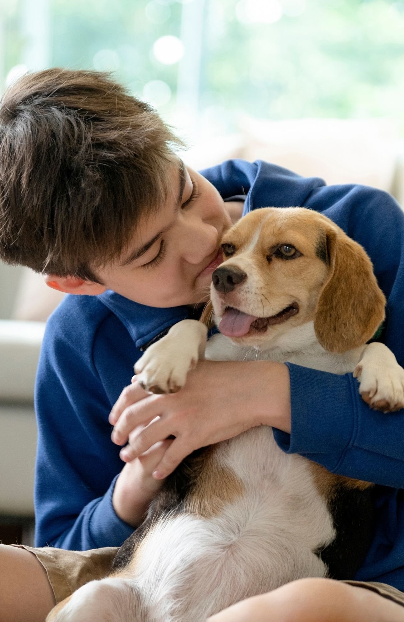 A boy hugging his dog learning about at-home pet euthanasia