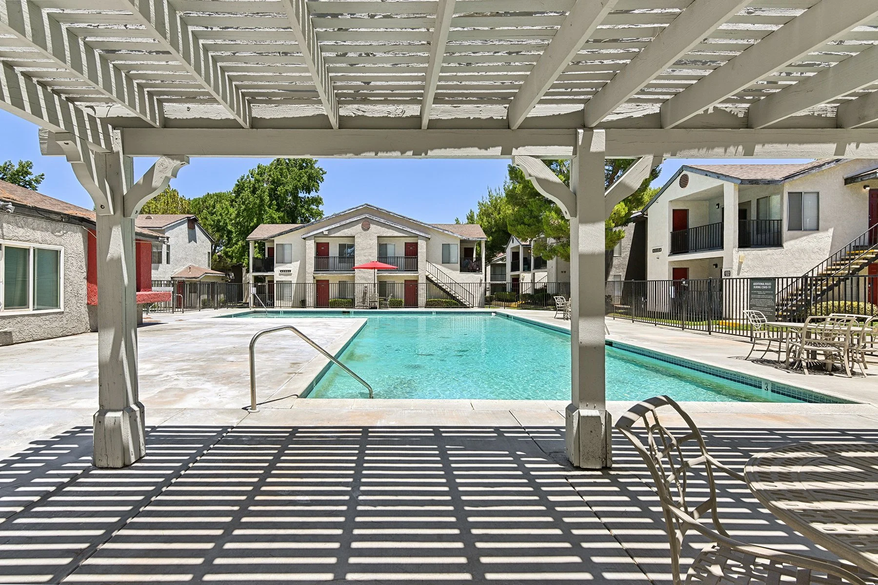 Sparkling Blue pool at Town Square Apartments with shaded seating