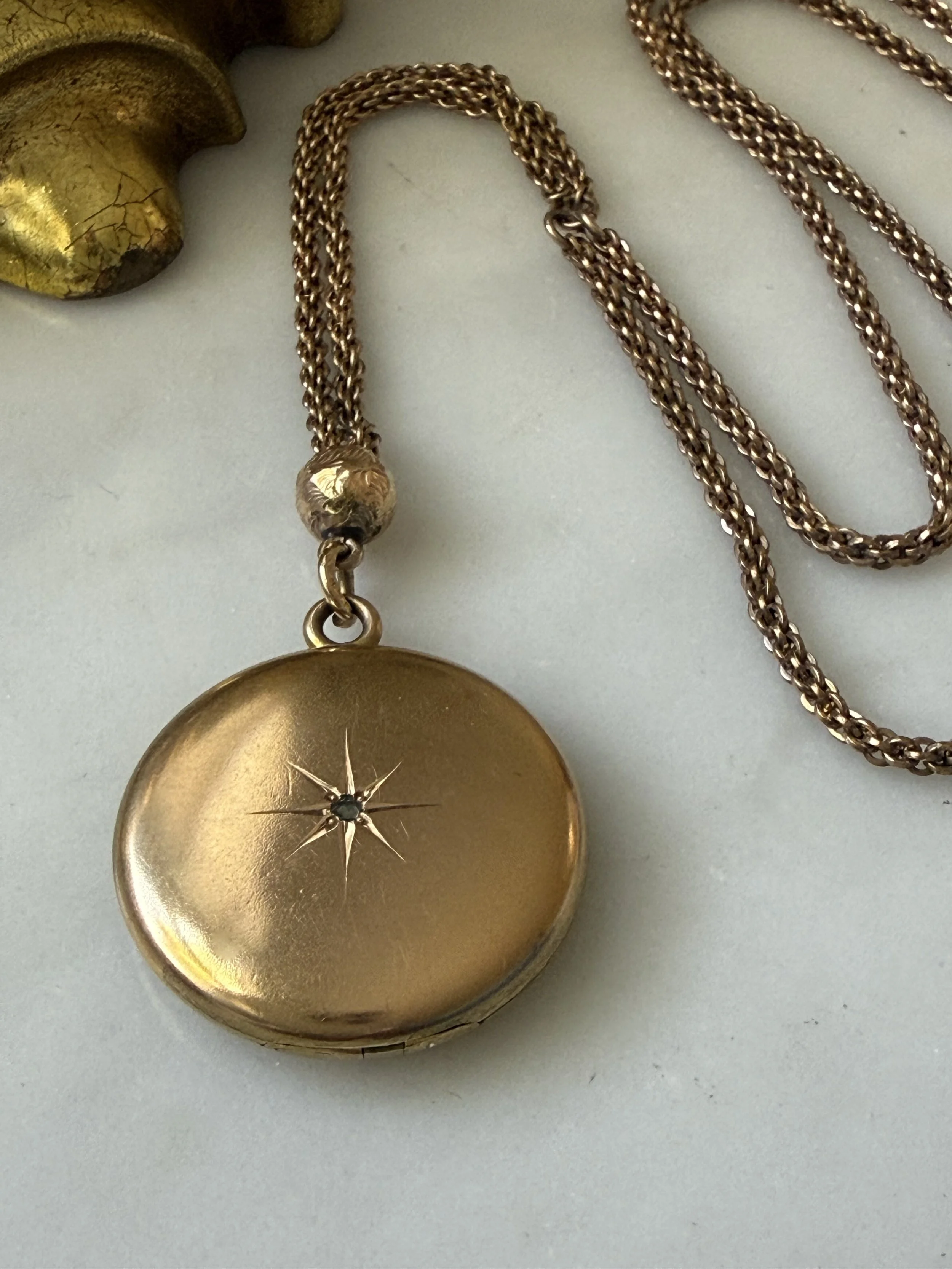 Edwardian star burst round locket with lariat style chain pairing