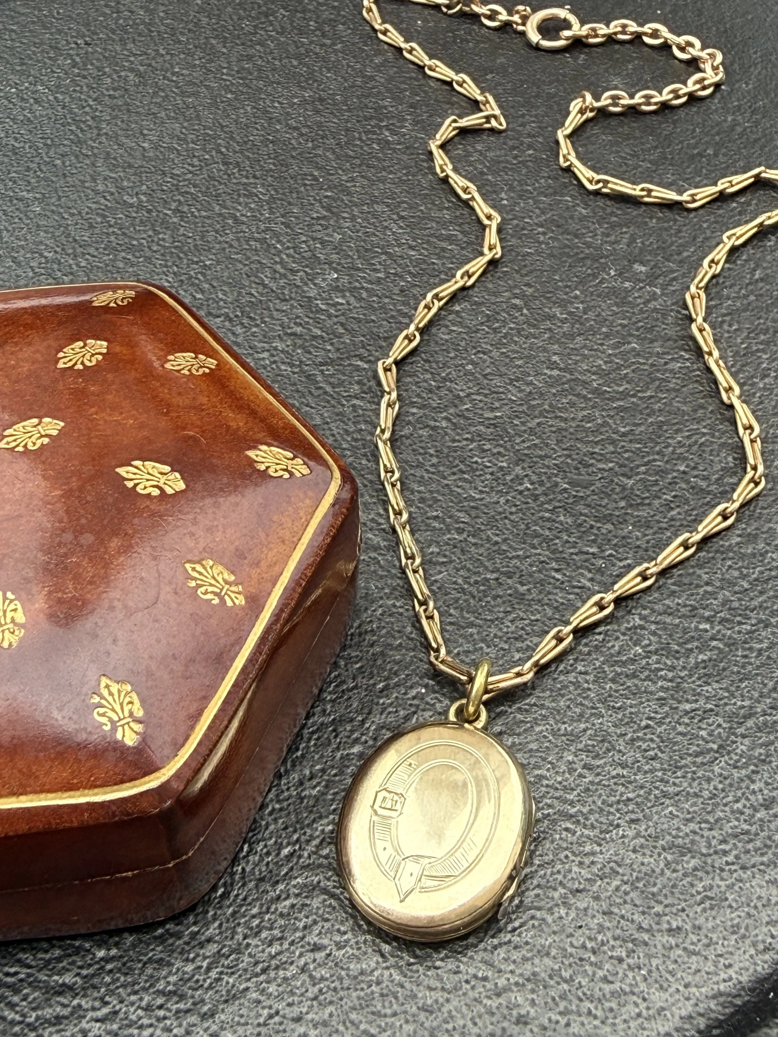 Late 19th century etched buckle strap locket with early 20th century chain