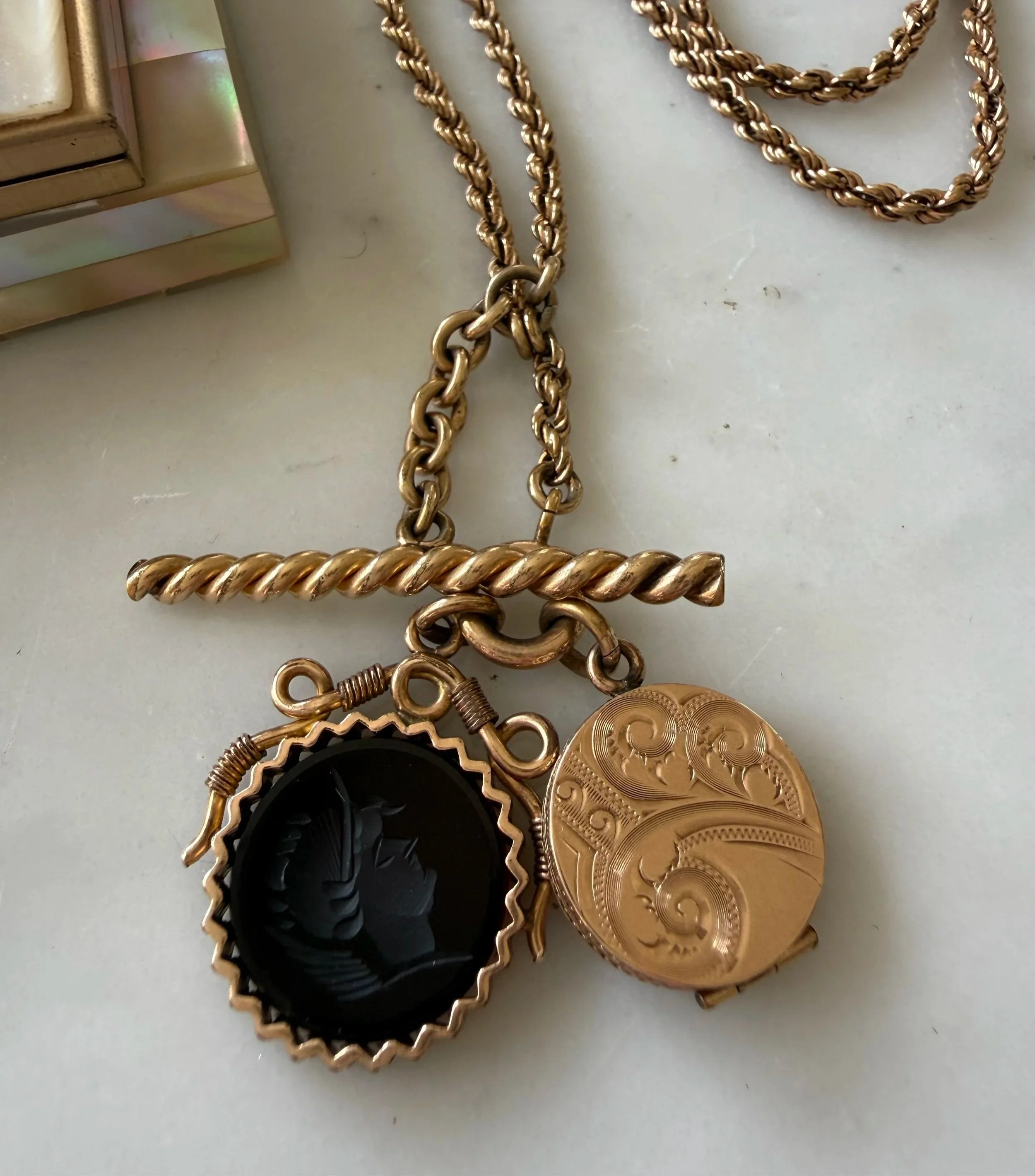 19th century agate intaglio, etched locket, and T-bar pairing on rope chain
