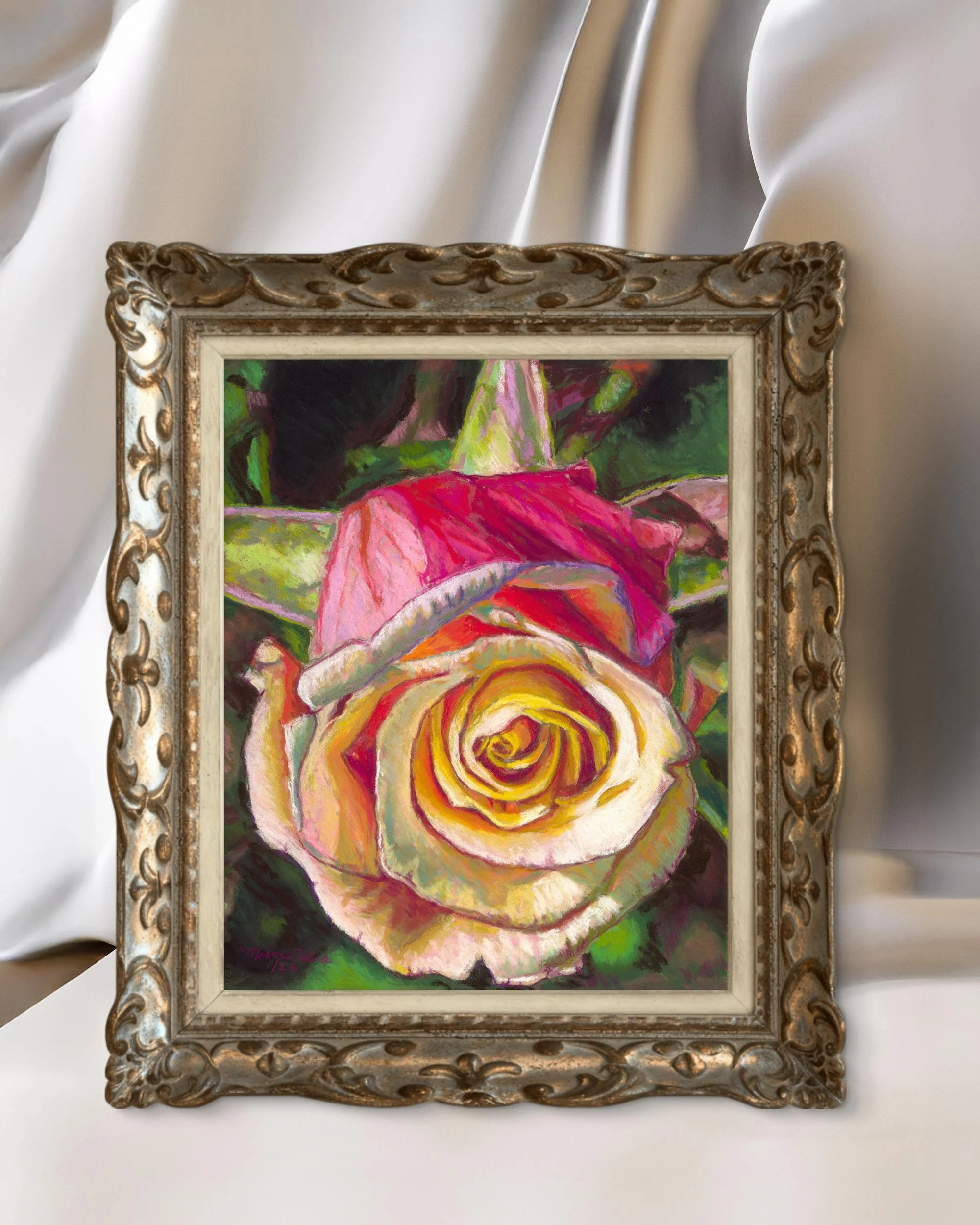Rose pastel painting in an ornate gold frame beside soft draped fabric