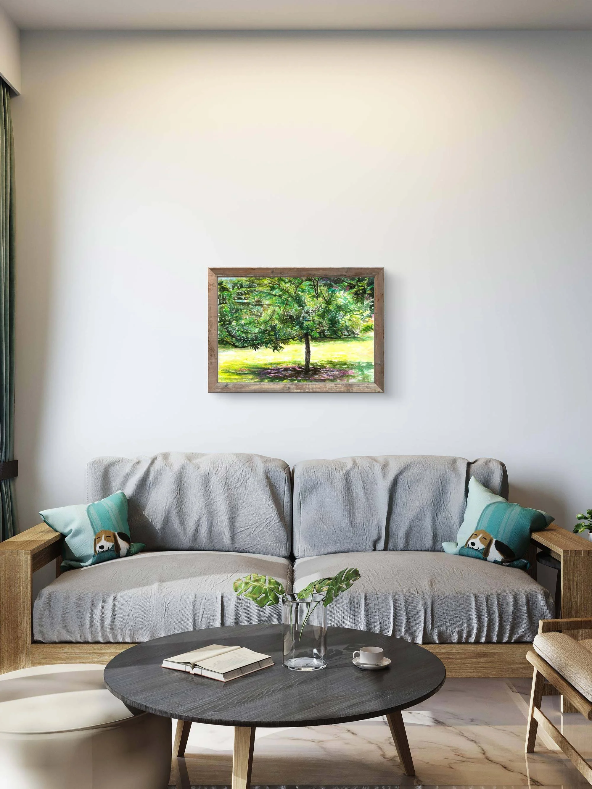 Framed watercolor tree hanging above a grey sofa with teal cushions