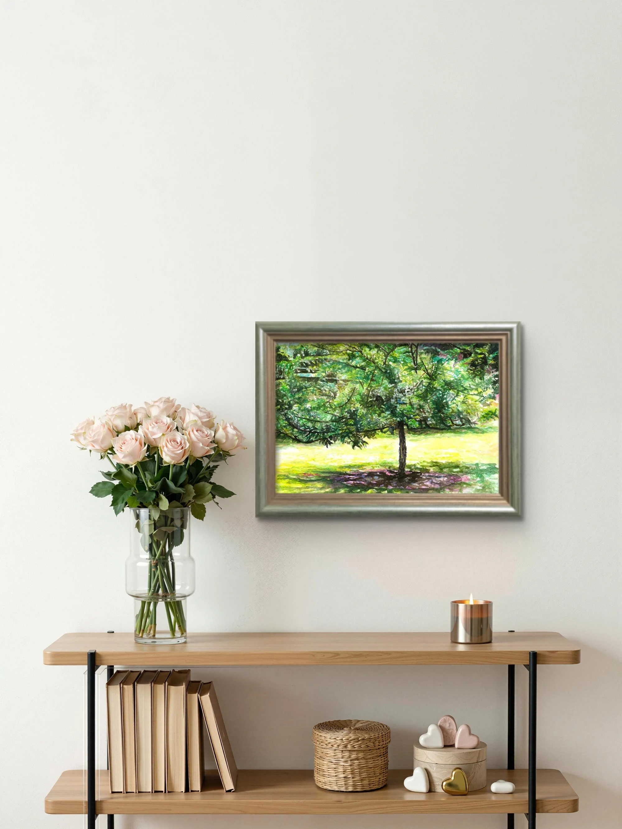 Crabapple tree watercolor in a silver frame above a console table with pale pink roses
