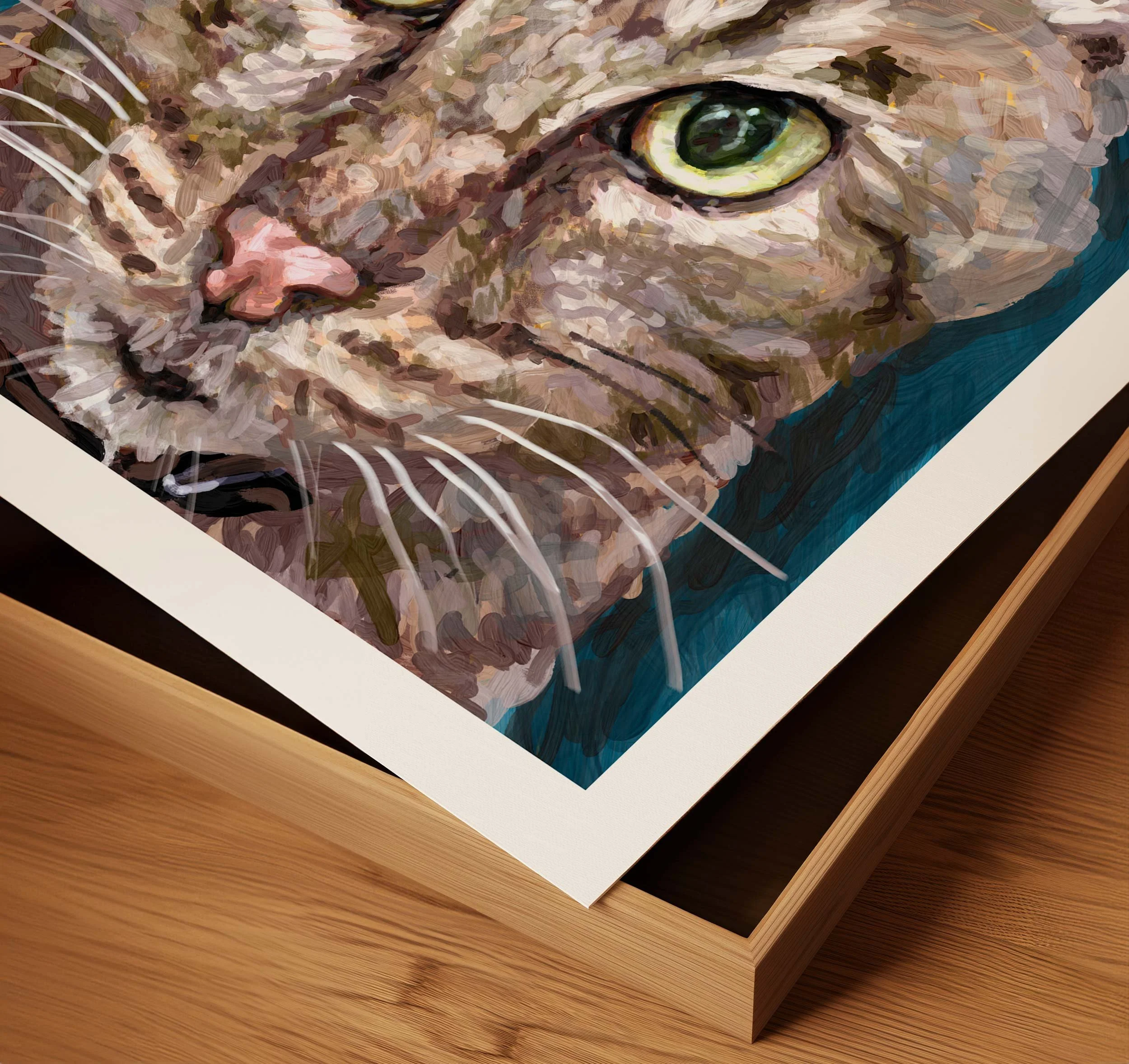 Corner detail of framed cat print showing the white mat and wood frame edge on a wood floor