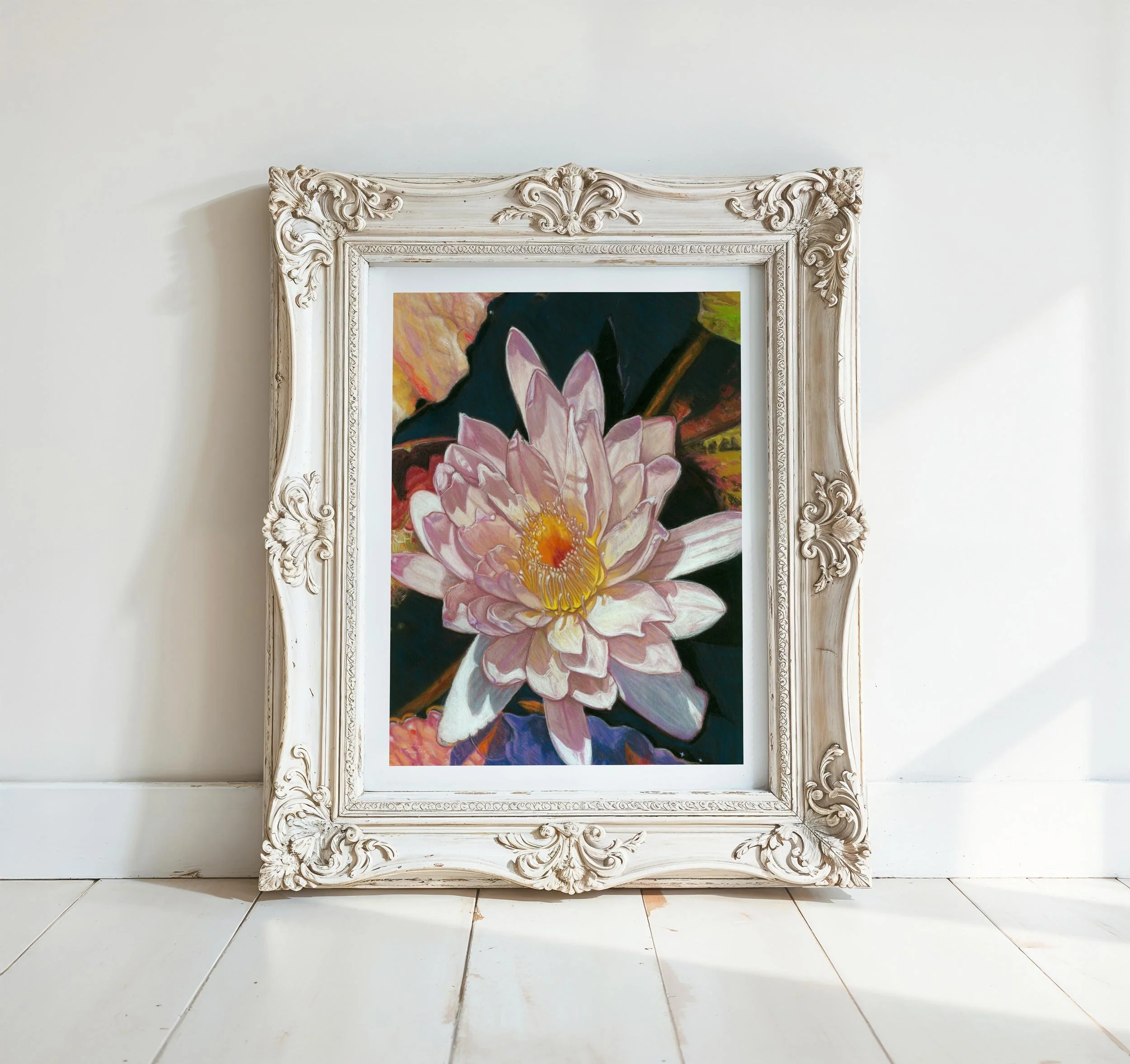 Framed white and pink water lily soft pastel print in ornate cream frame, leaning against a white wall on white wood floor
