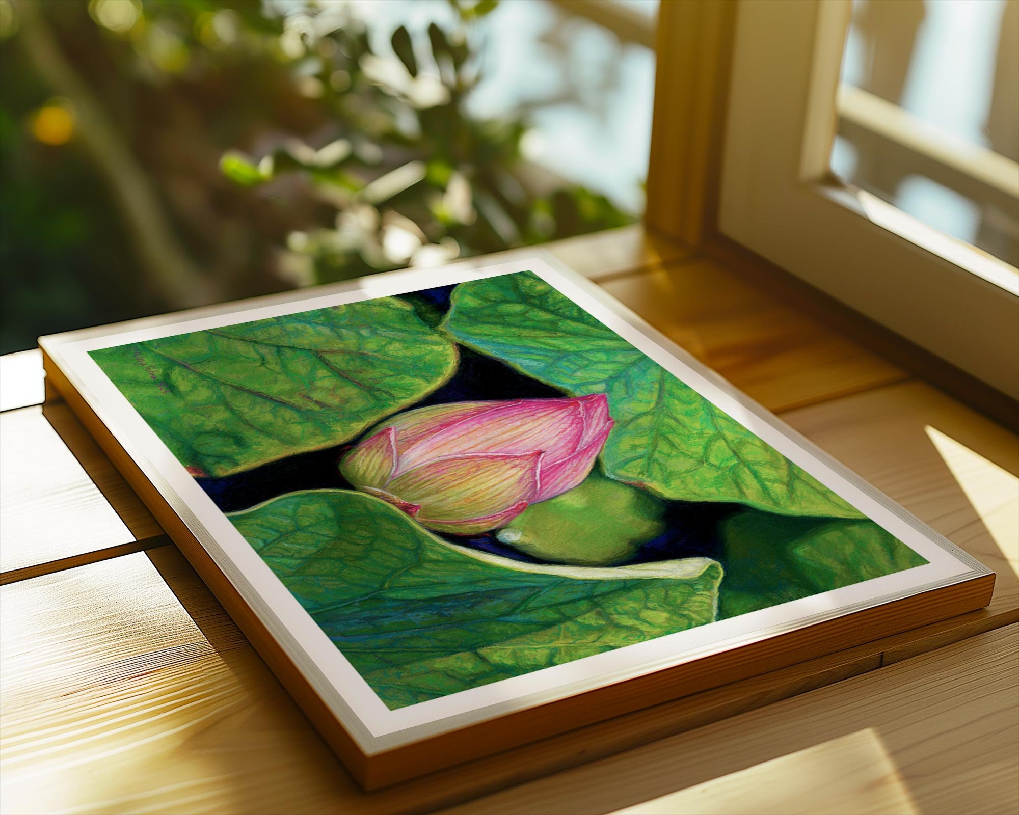 Lotus fine art print laying flat on a wooden frame on a wooden table