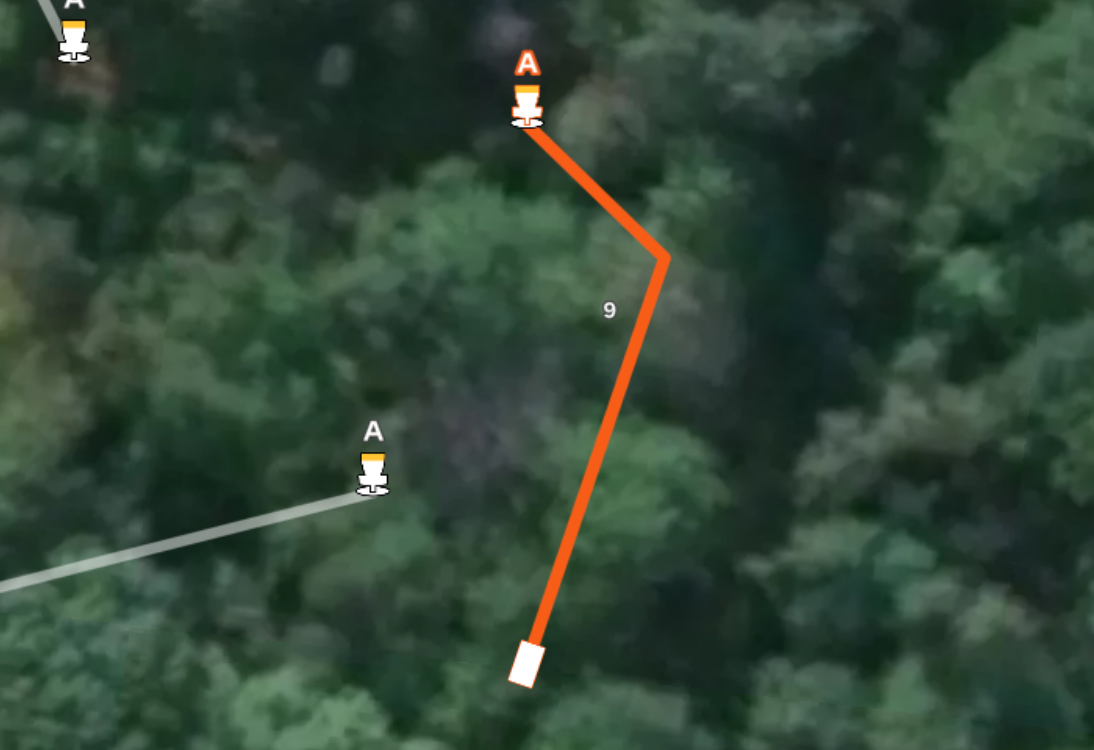 Gemini said Aerial map of hole #9 at Sand Ridge Disc Golf Course. It features an orange flight path through a dense wooded area that doglegs left toward basket A.