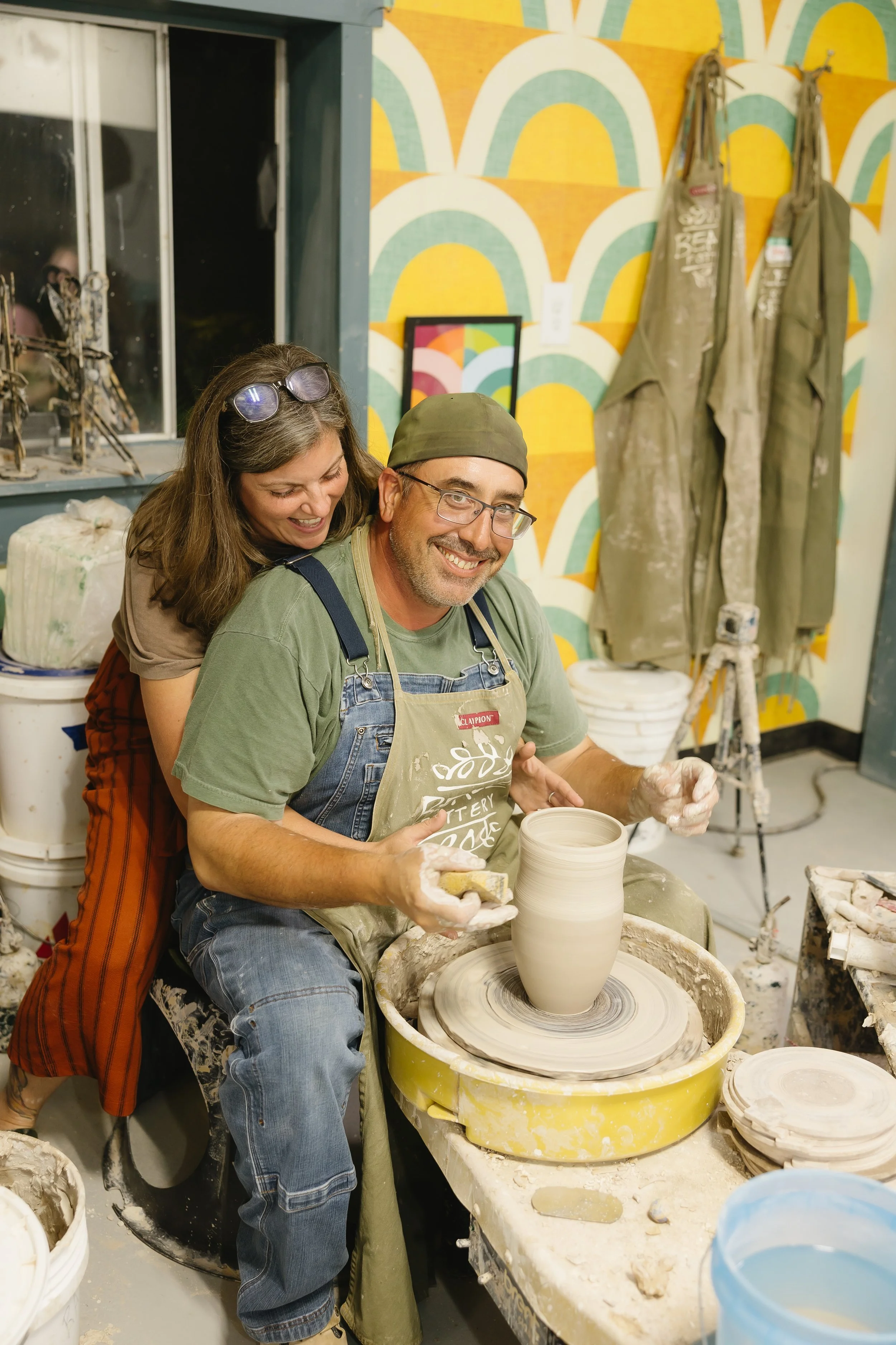 Milissa and Eric Beale at Beale Pottery goofing at the wheel.