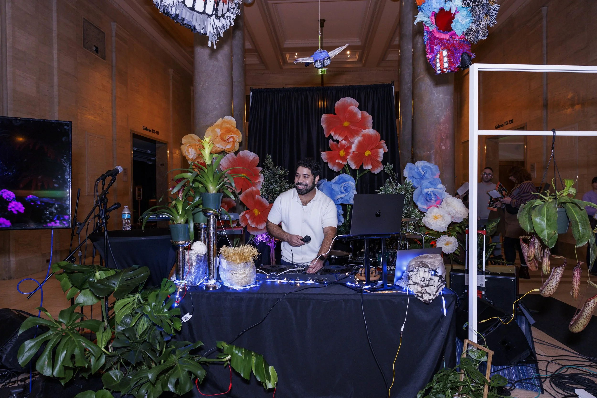 Jon Sabilon begins his DJ set surrounded by real plants, faux trees, and giant flowers.