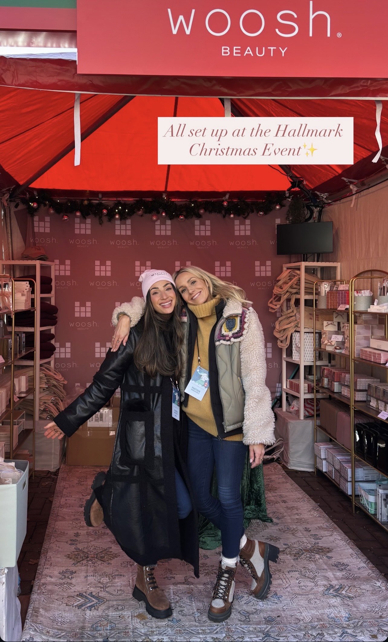 final woosh beauty booth set up at the hallmark christmas experience with two staff members standing