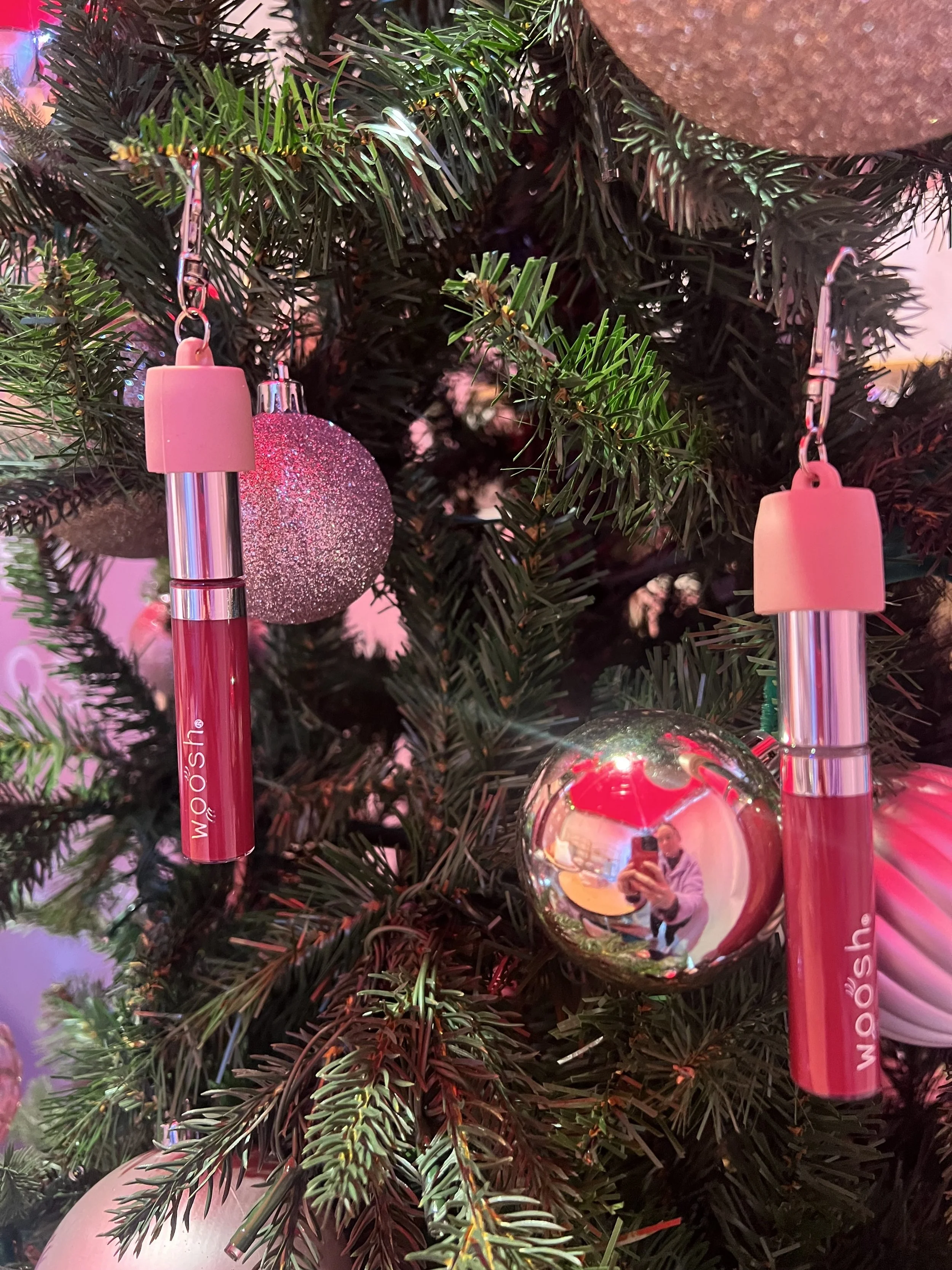 christmas tree with light pink ornaments and woosh lip gloss displayed