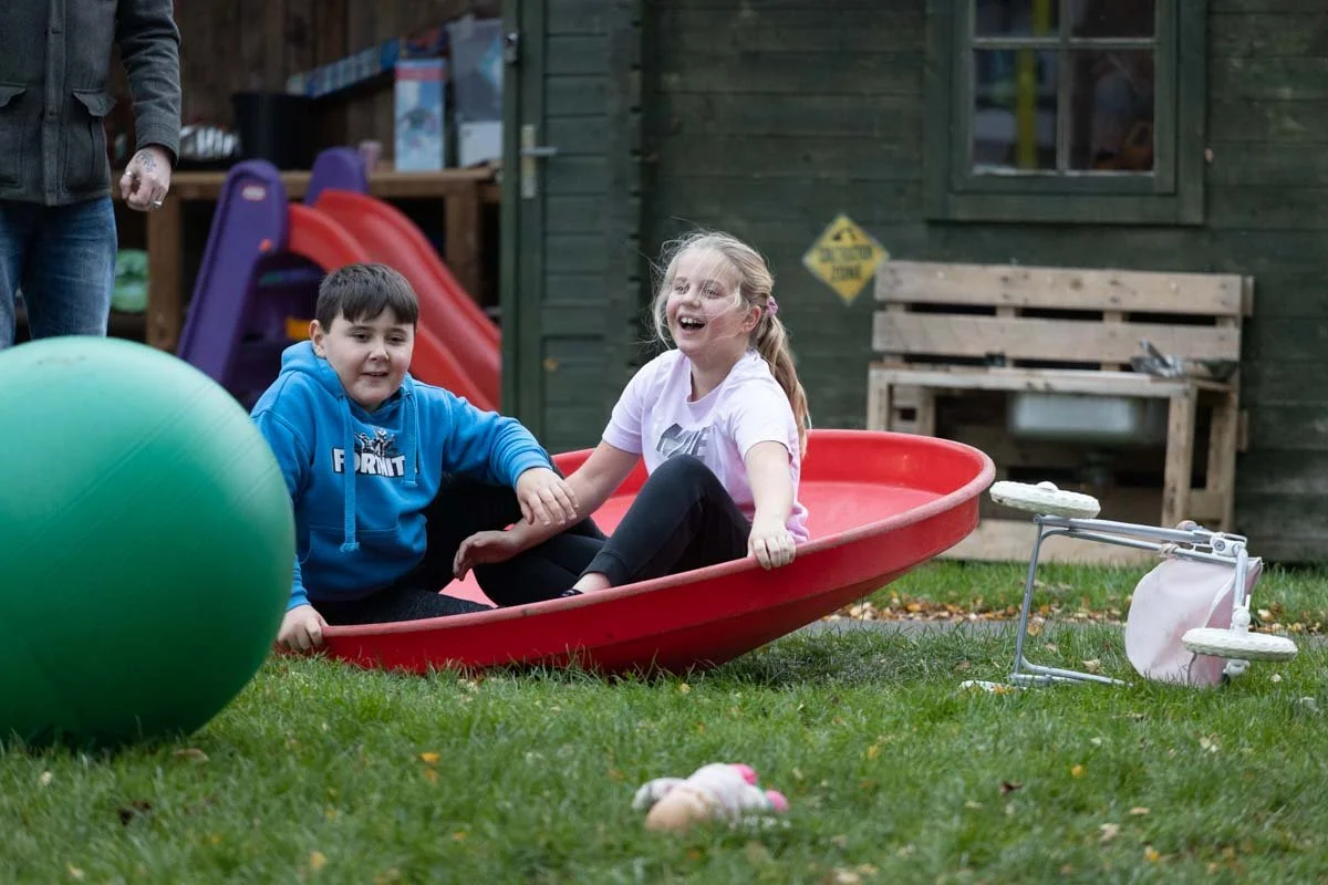 Two children playing in the garden at GL11