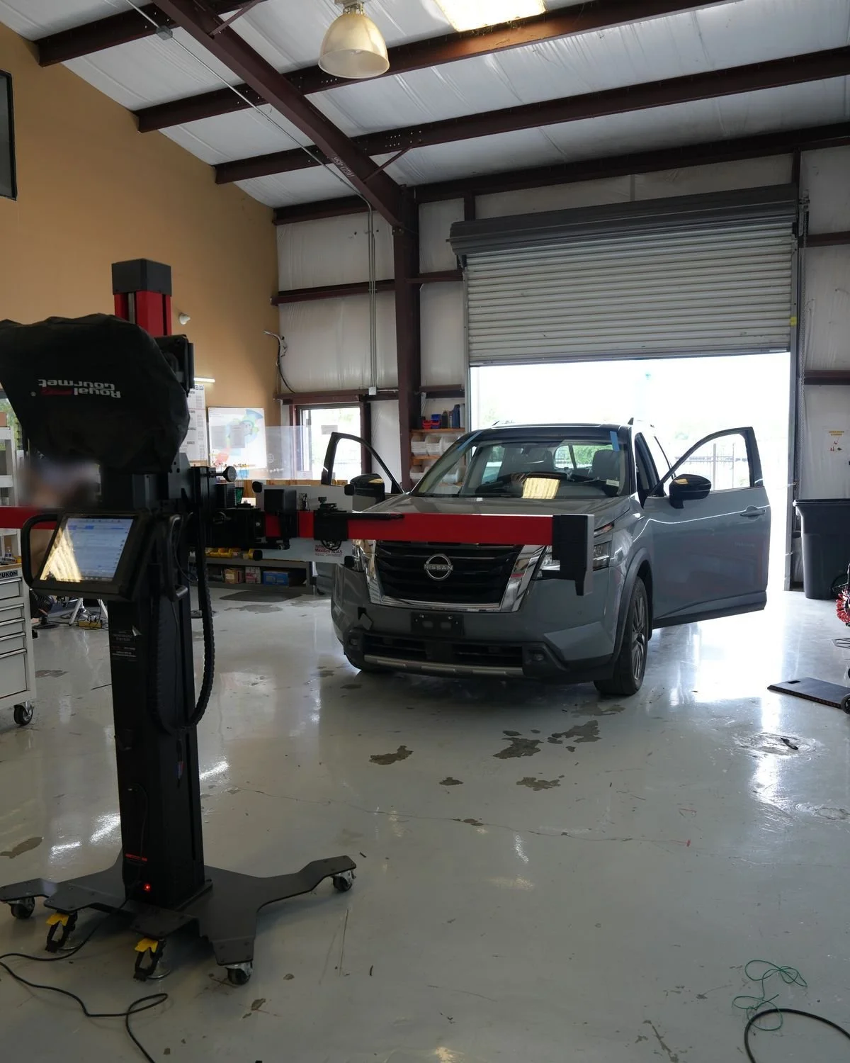 ADAS calibration equipment set up in front of an SUV in the DNA Safety Repair shop