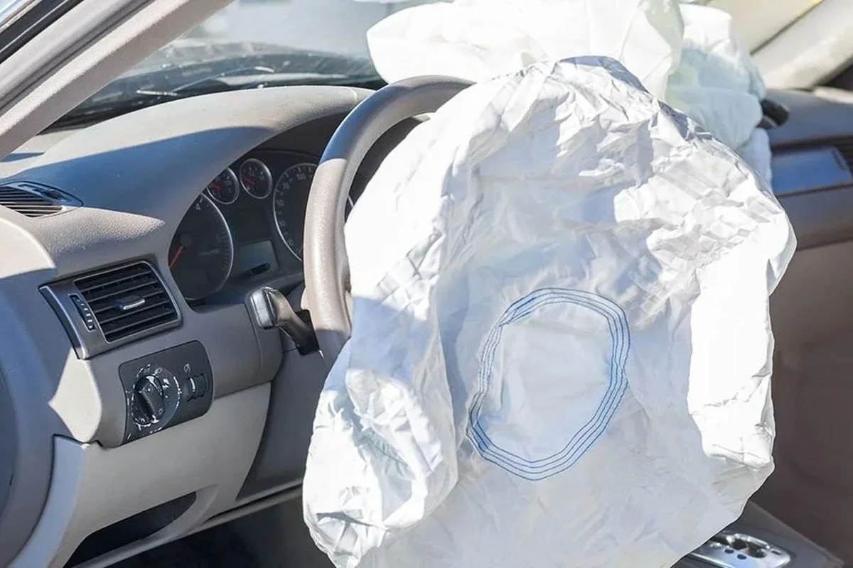 Deployed driver airbag hanging from a steering wheel