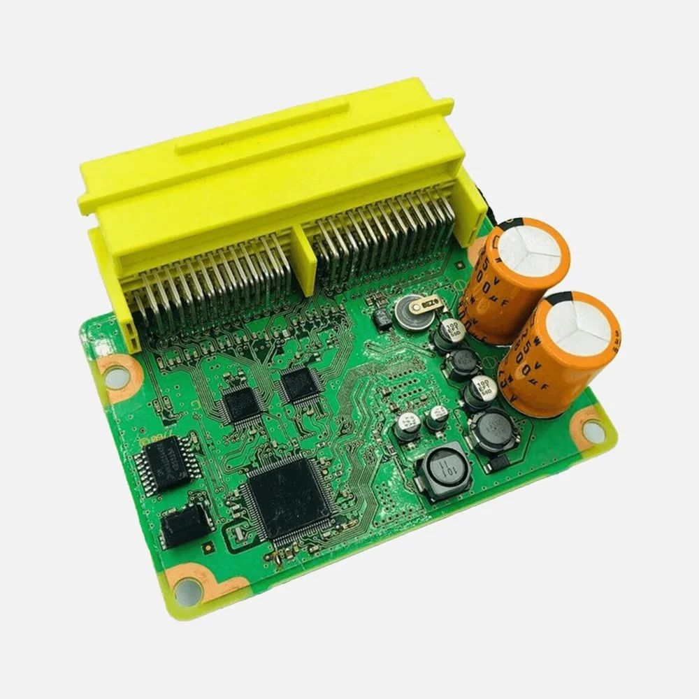 Exposed airbag module circuit board with a yellow connector and capacitors