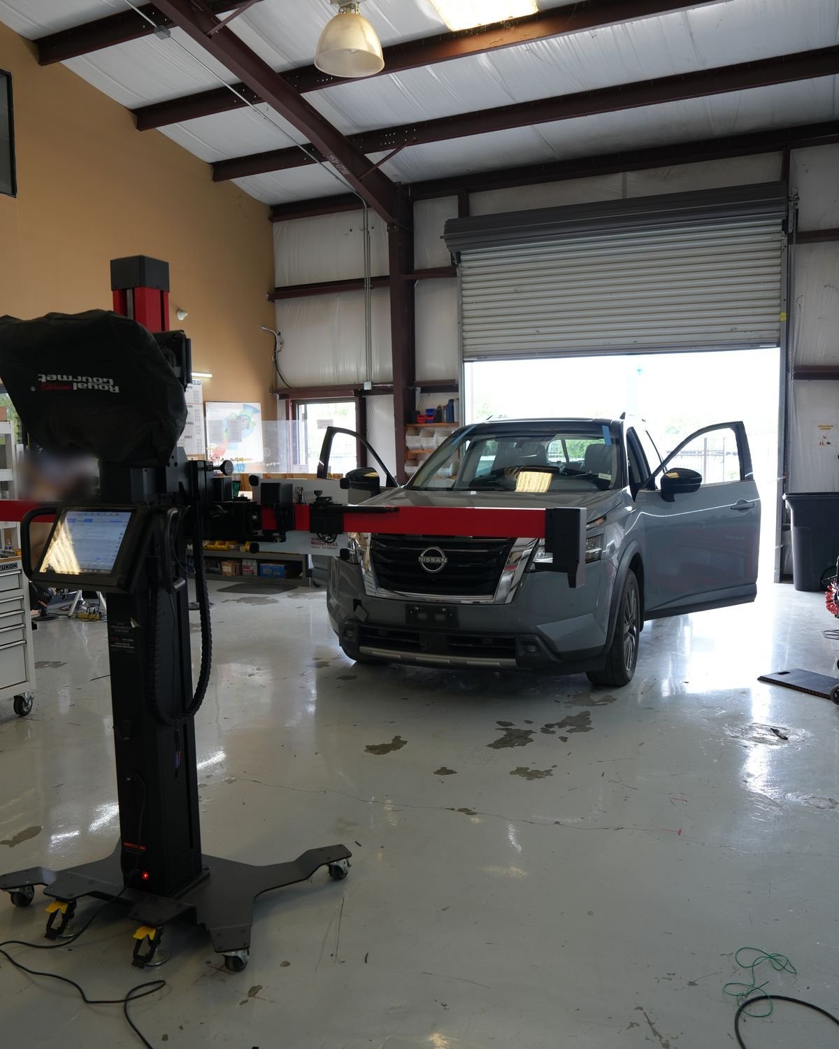 ADAS calibration frame set up at the front of an SUV in the DNA Safety Repair shop