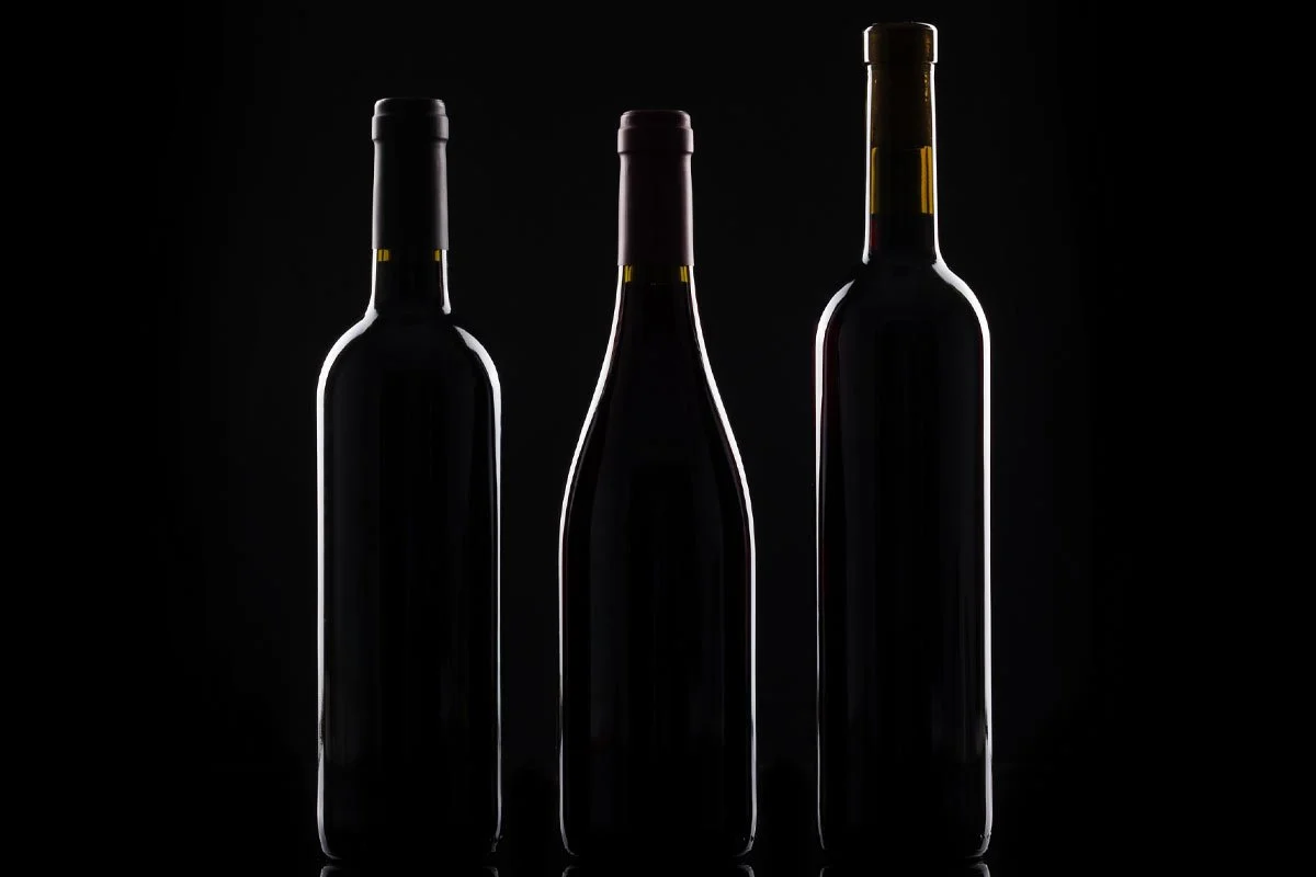 Silhouette of three wine bottles.