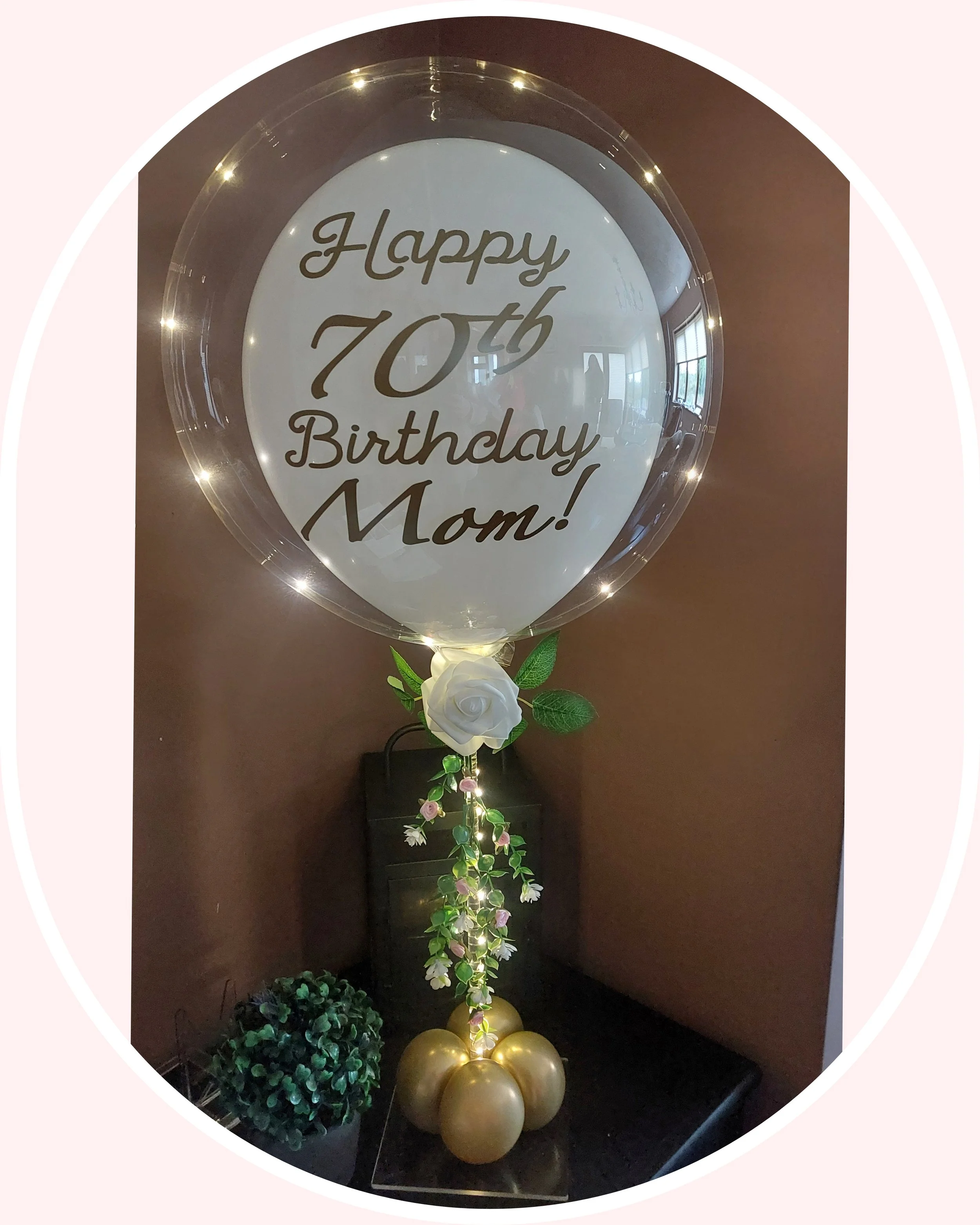 ITEM #177 --- Bubble balloon with white balloon filler with flowers.