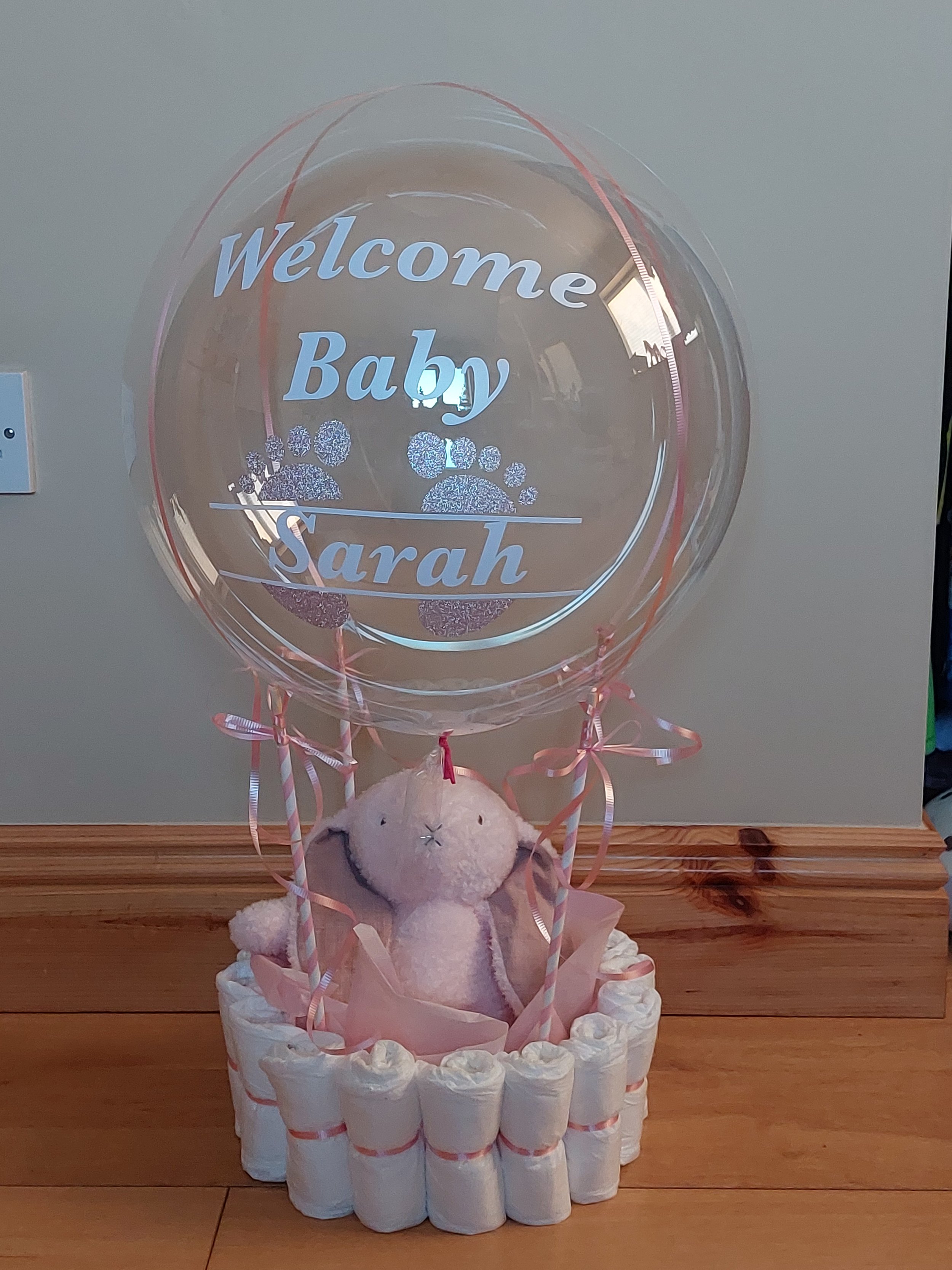 ITEM #93
€55
Personalised hot air balloon inspired balloon display. The basket is made from nappies and the basket contains a bunny teddy.
