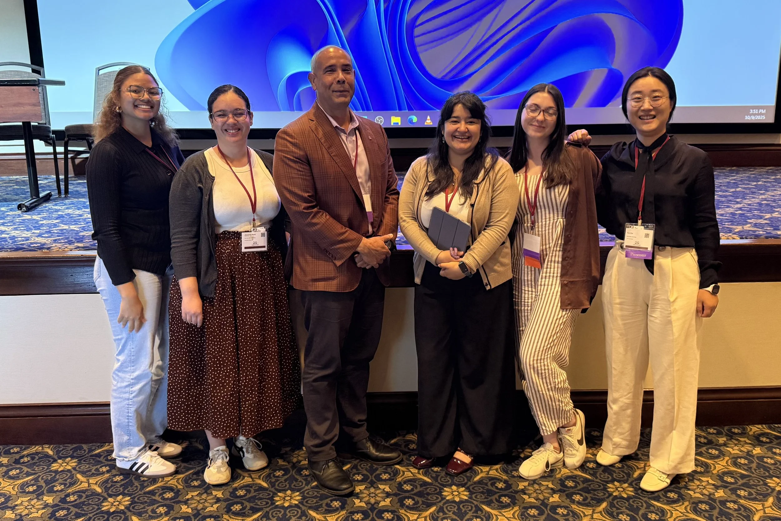 a group of students pose at a conference after their presentation