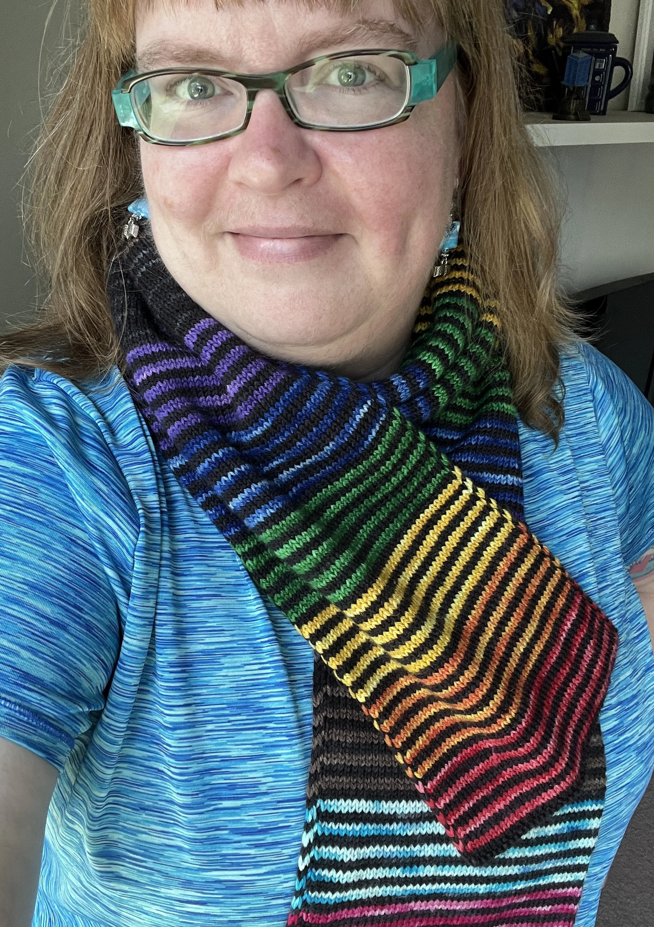 a woman wearing a rainbow scarf