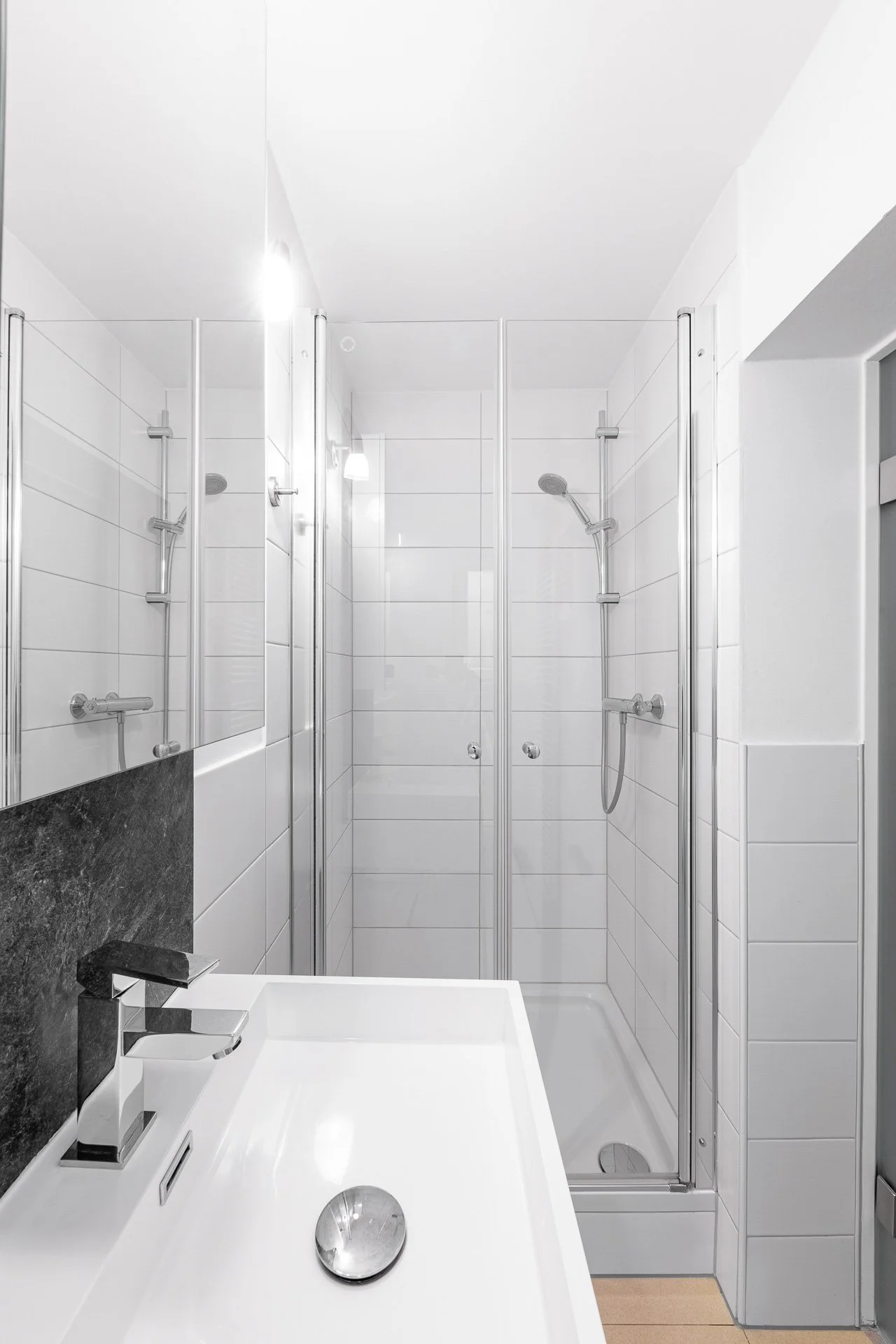 Modernes Badezimmer mit Duschkabine und Waschbecken.