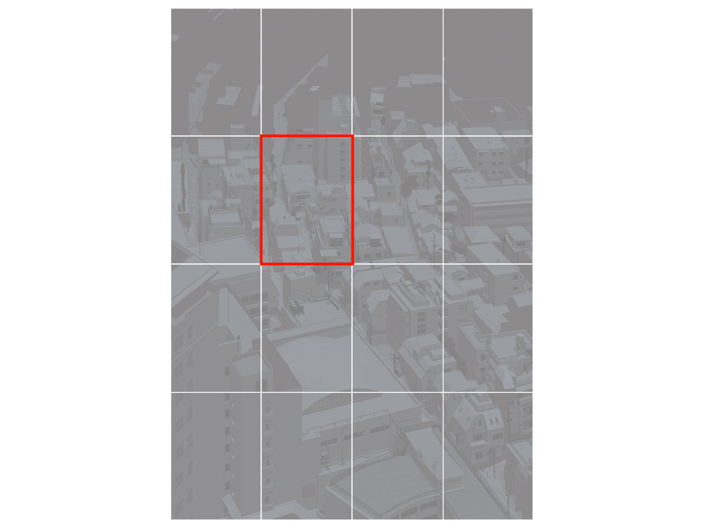 Nighttime aerial view of a dense urban area with various buildings, rooftops, and streets illuminated faintly, captured from a high angle.